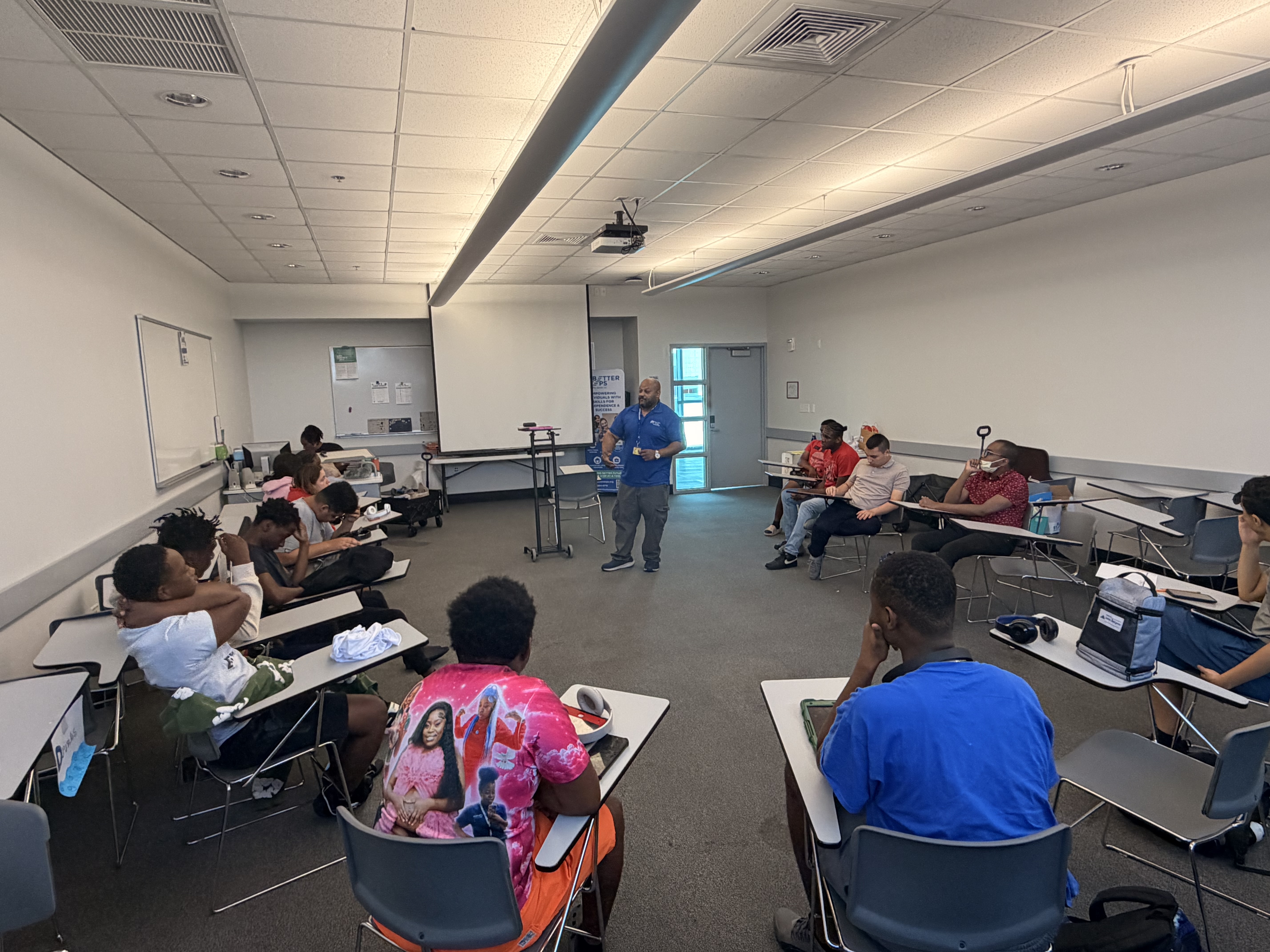 Diverse group of young adults with disabilities participating in interactive life skills and workplace readiness training workshop led by instructor in modern classroom setting at Better Steps Life Skills Center in Florida