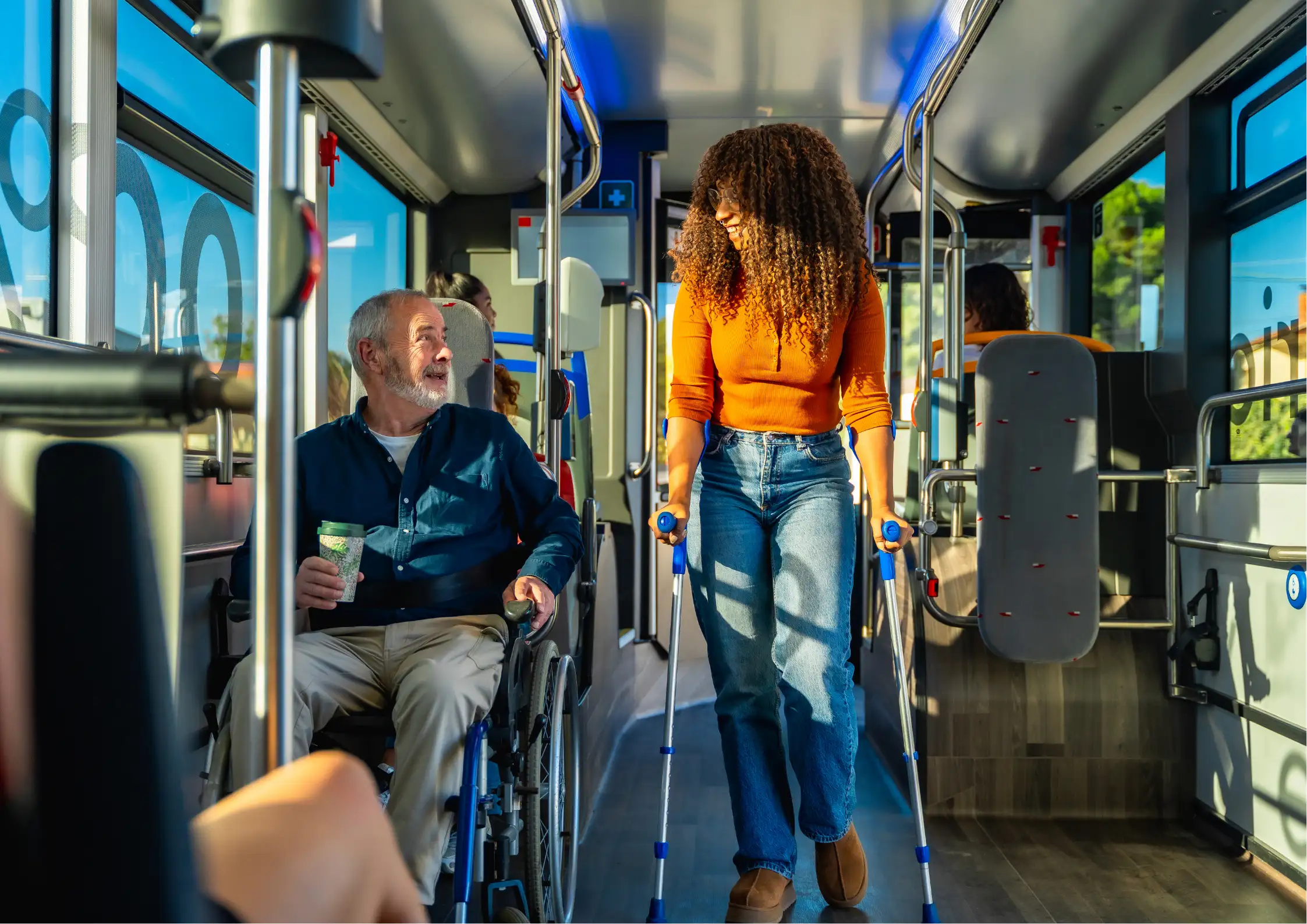 Passengers with mobility aids navigating a public city bus safely to demonstrate community transportation skills.