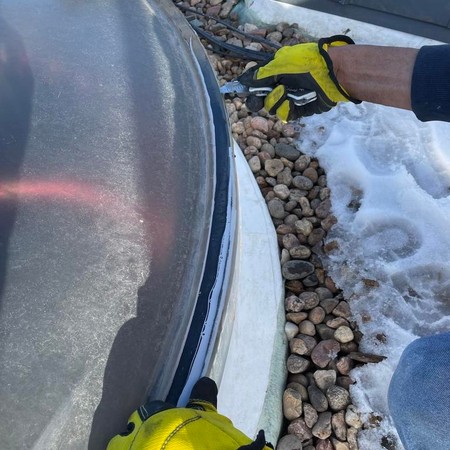 Roofer inspecting residential roof in Parker Colorado