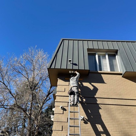 Roofer inspecting residential roof in Parker Colorado