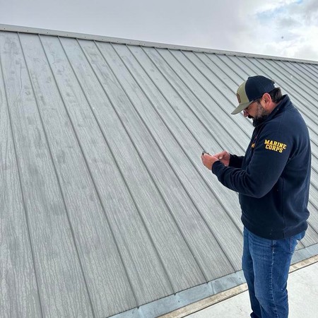 Roofing crew replacing asphalt shingles on Parker home
