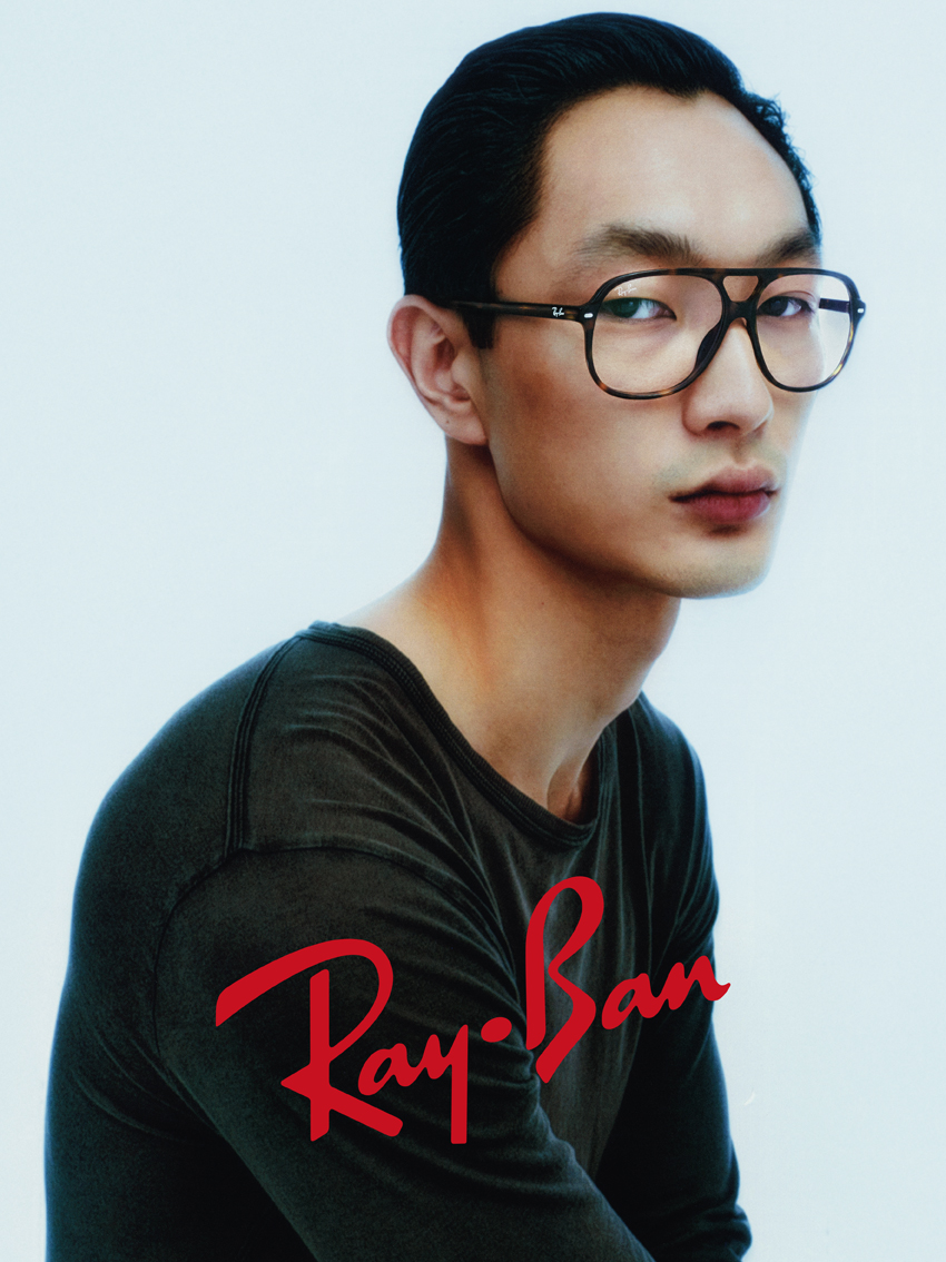 Man wearing Ray-Ban tortoiseshell acetate double-bridge aviator eyeglasses with clear lenses and a dark top