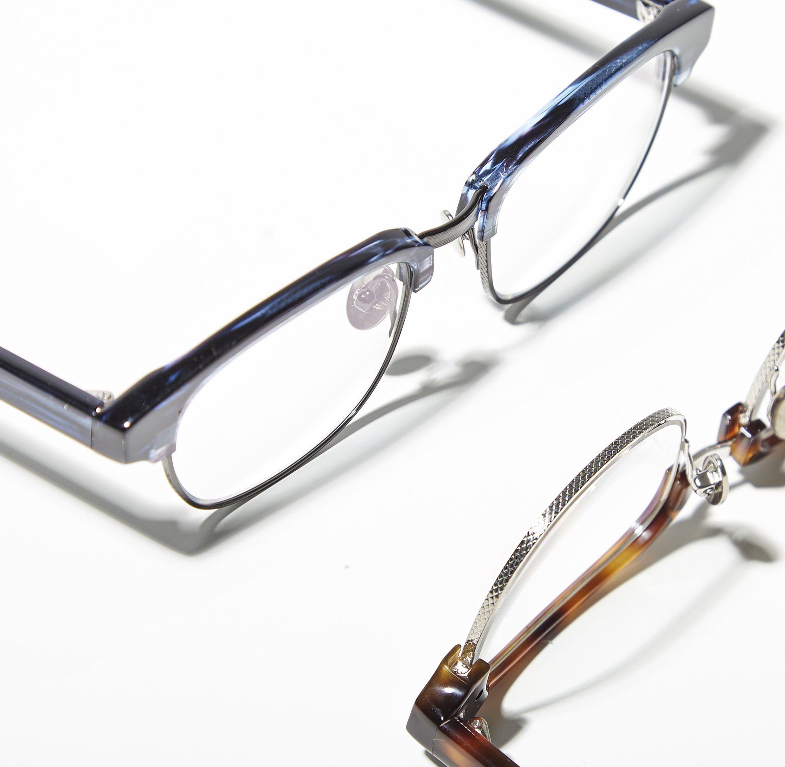 Macro detail of Kala eyewear frame hinges, showing acetate and metal craftsmanship