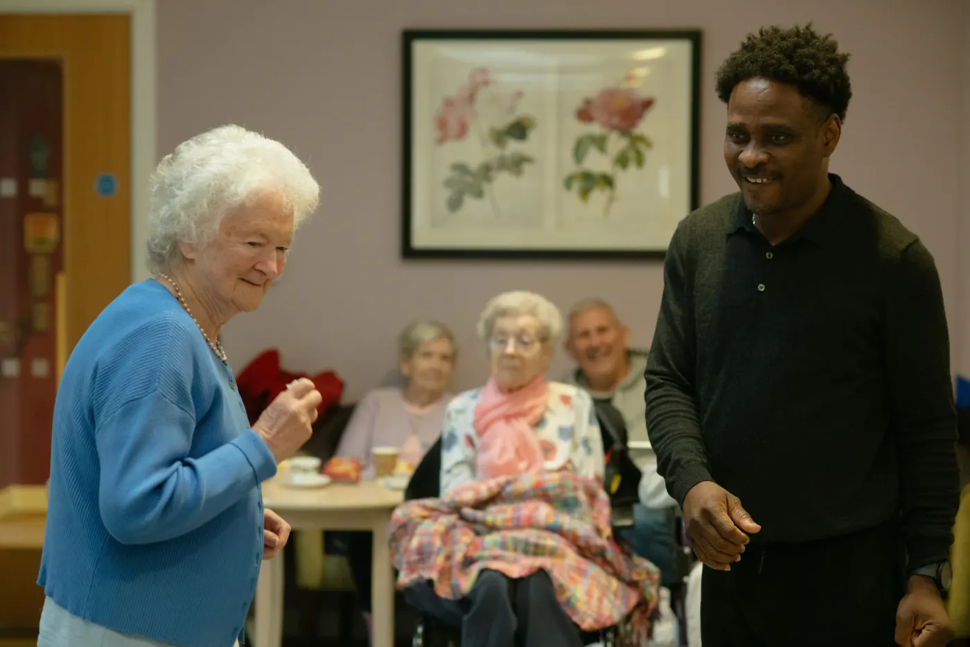 Nurse holding a resident's hand