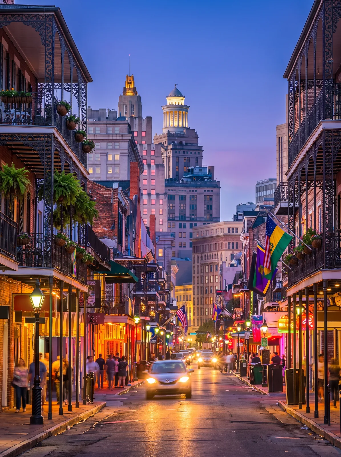 Bourbon Street in the New Orleans French Quarter at dusk, with iron balconies and Mardi Gras flags