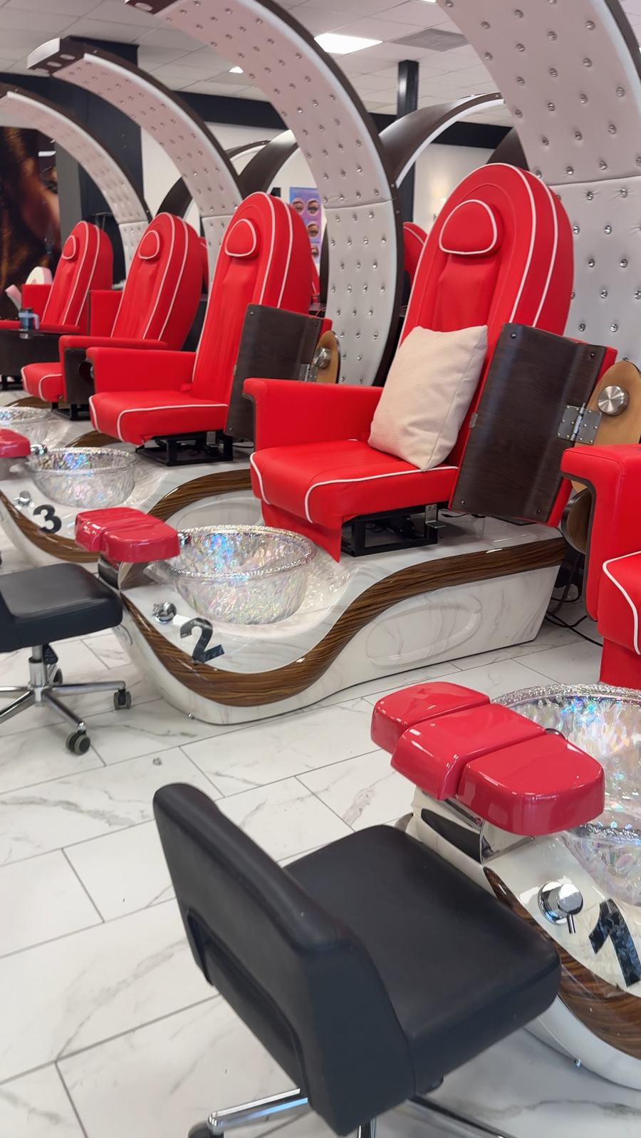 Red massage pedicure chairs under white crystal-studded arches at Allure Nail Bar in Norcross, GA