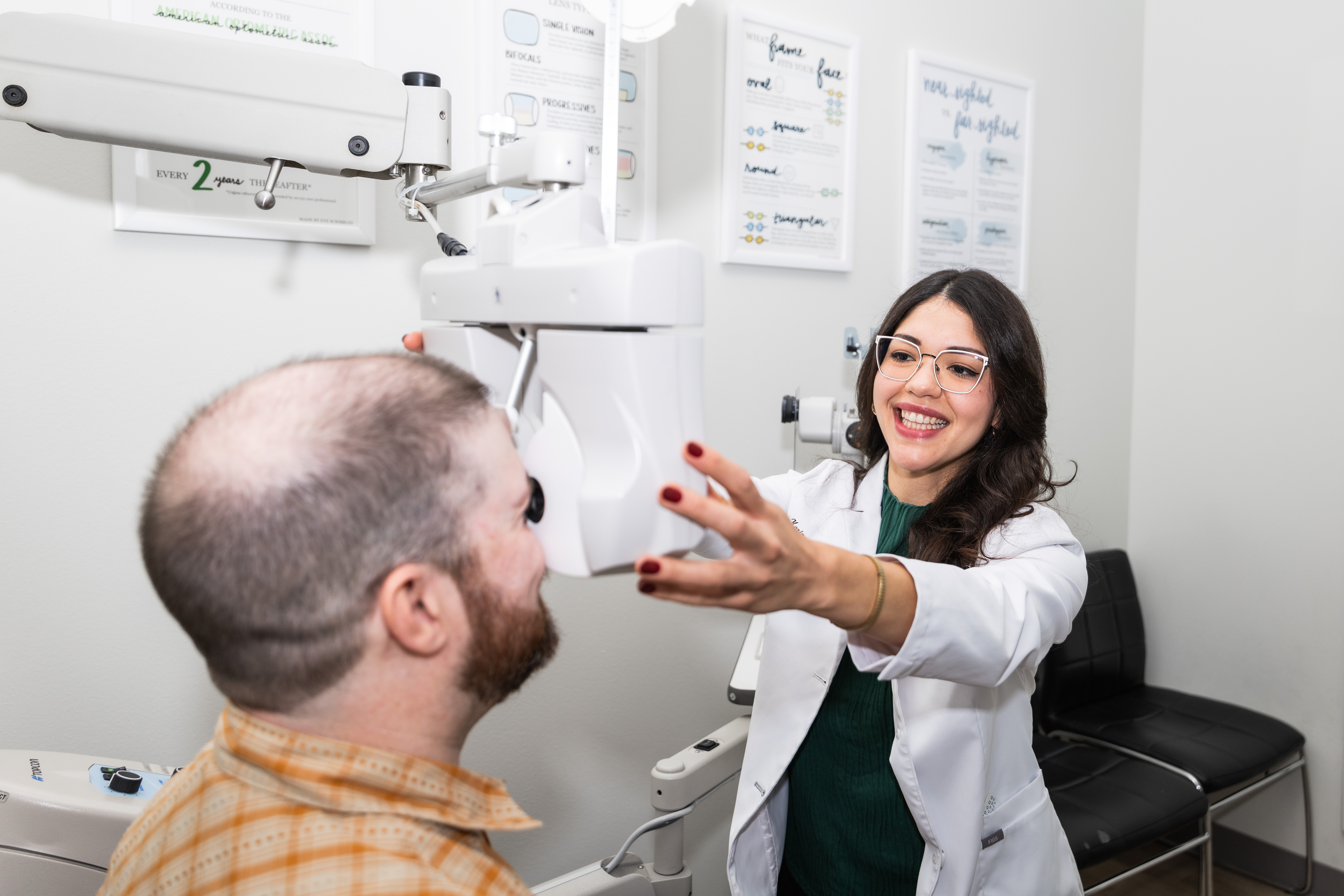 Dr. Karine Combe positioning a phoropter during a binocular vision and prism evaluation at Envision Eye Center in East Austin