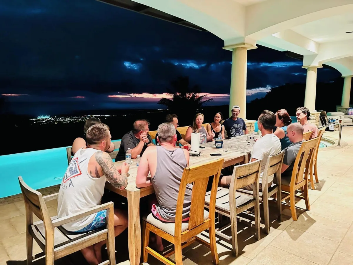 Group dinner poolside at dusk