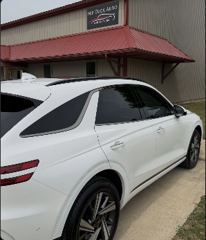 White vehicle with dark professional window tint outside Nip Tuck Auto