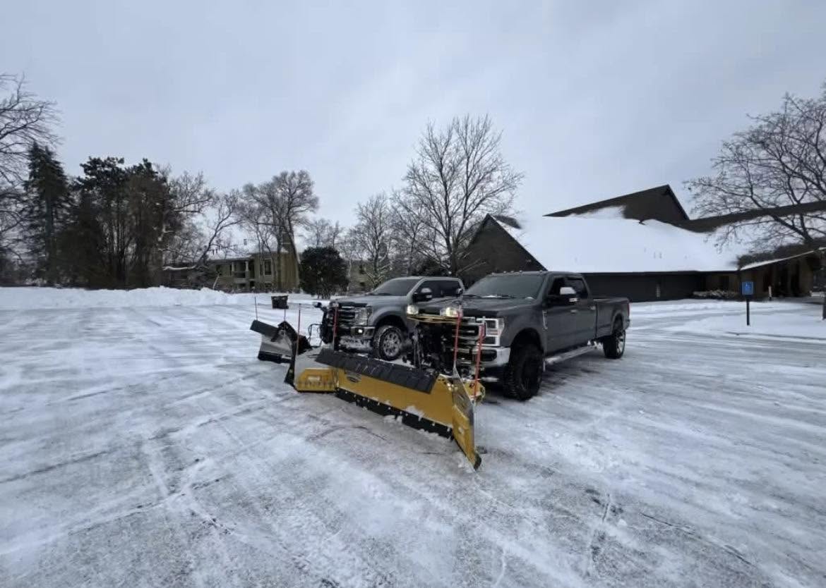 Yard Relief Services plow truck clearing a snowy parking lot in Edmonton
