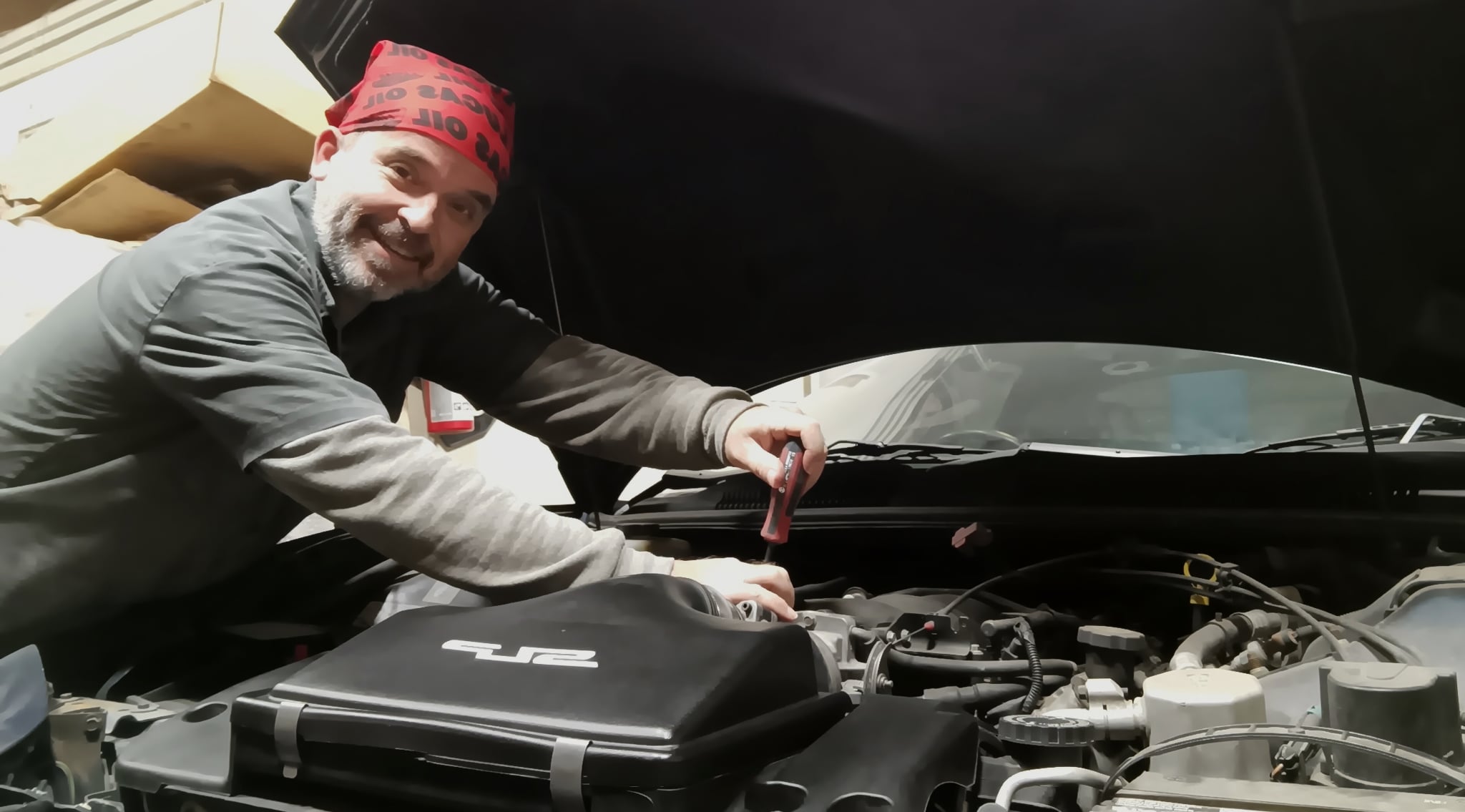 Ted Fox, founder of Scooter's Garage, working under the hood