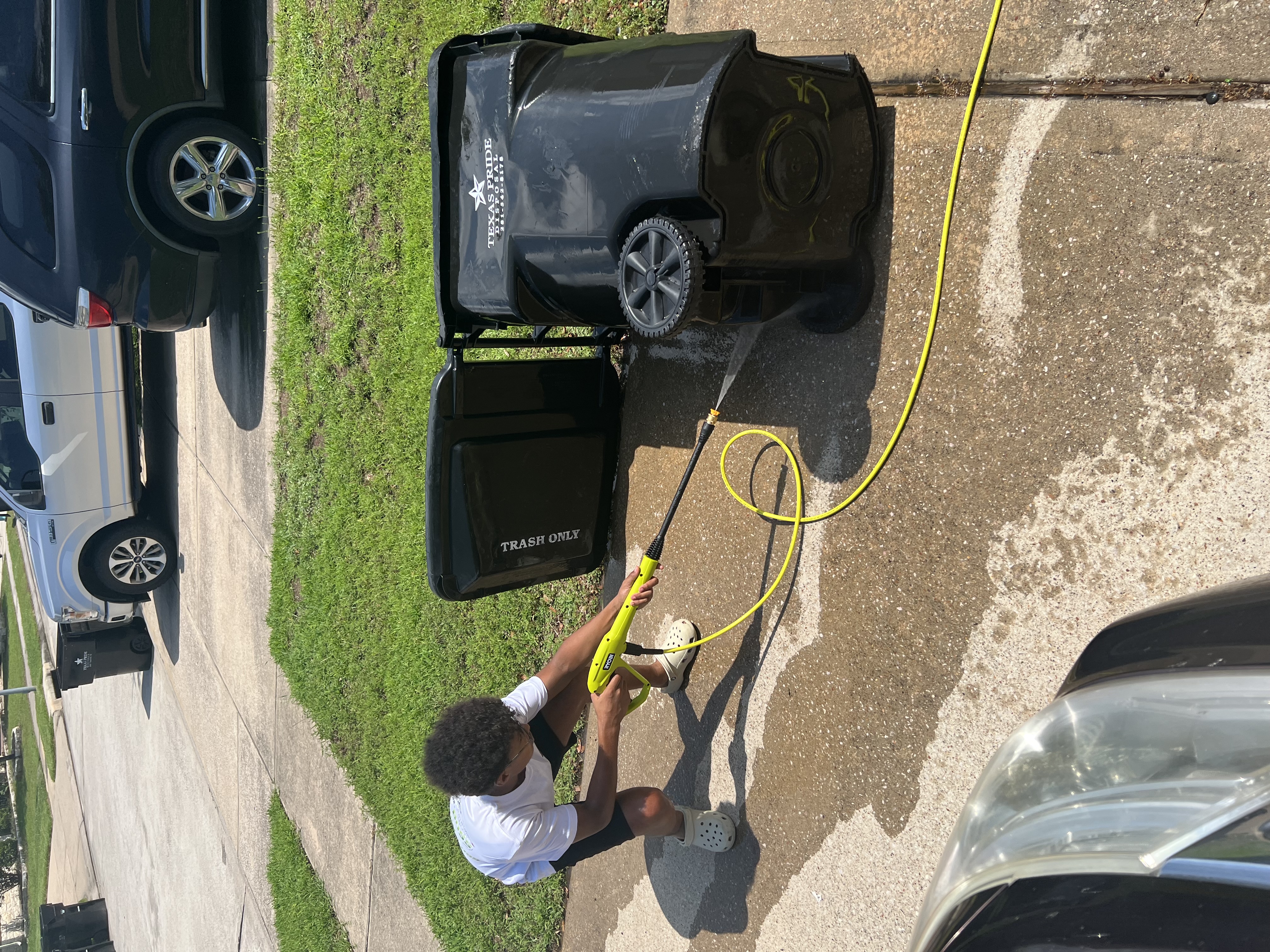 Tristin cleaning a trash bin