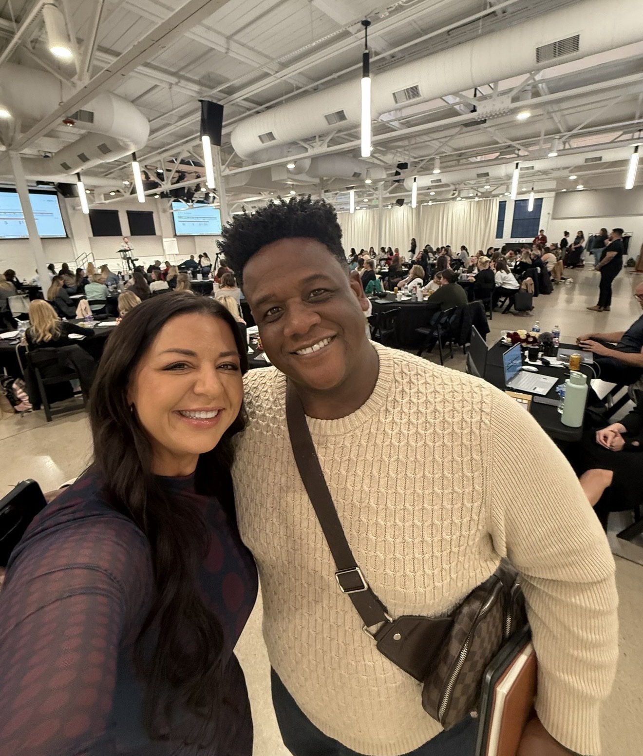 Dr. Elise with a member at a packed ChiroIntensive live event