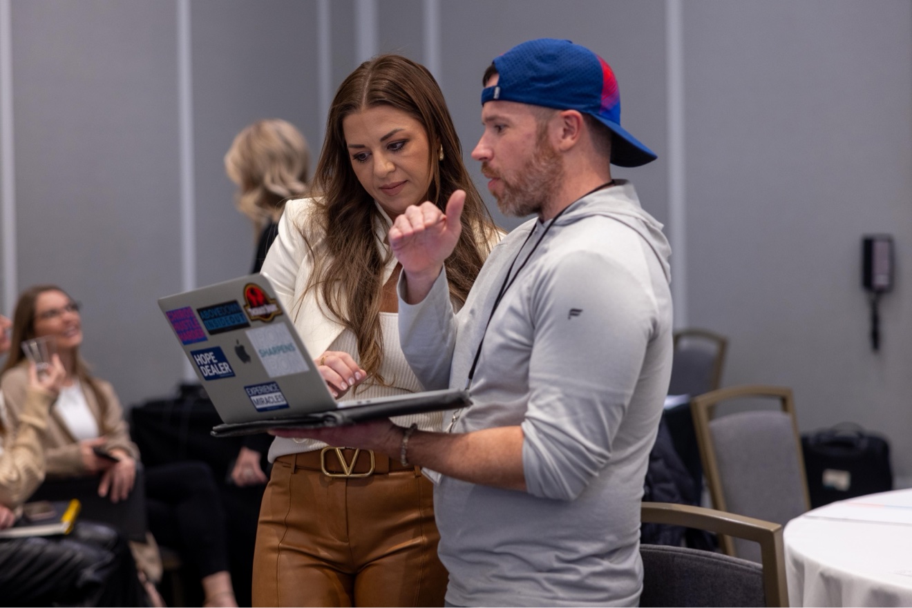 Two members working through something on a laptop