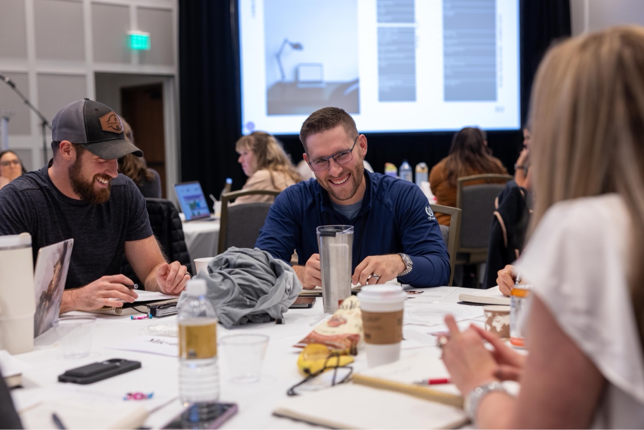 Male doctors laughing and working together at a table