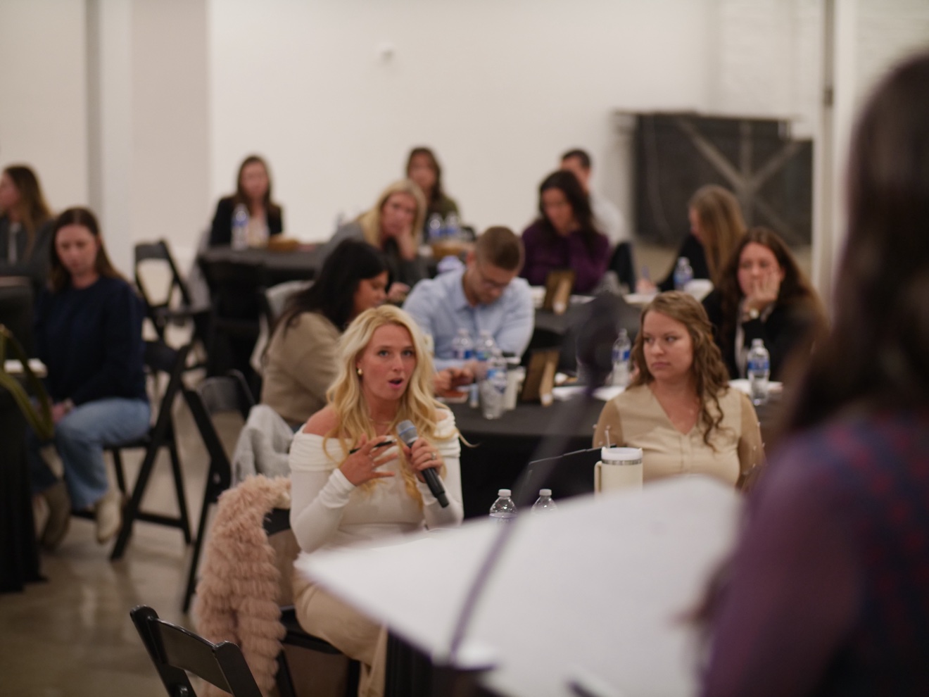 A member speaking into a microphone at a ChiroIntensive event