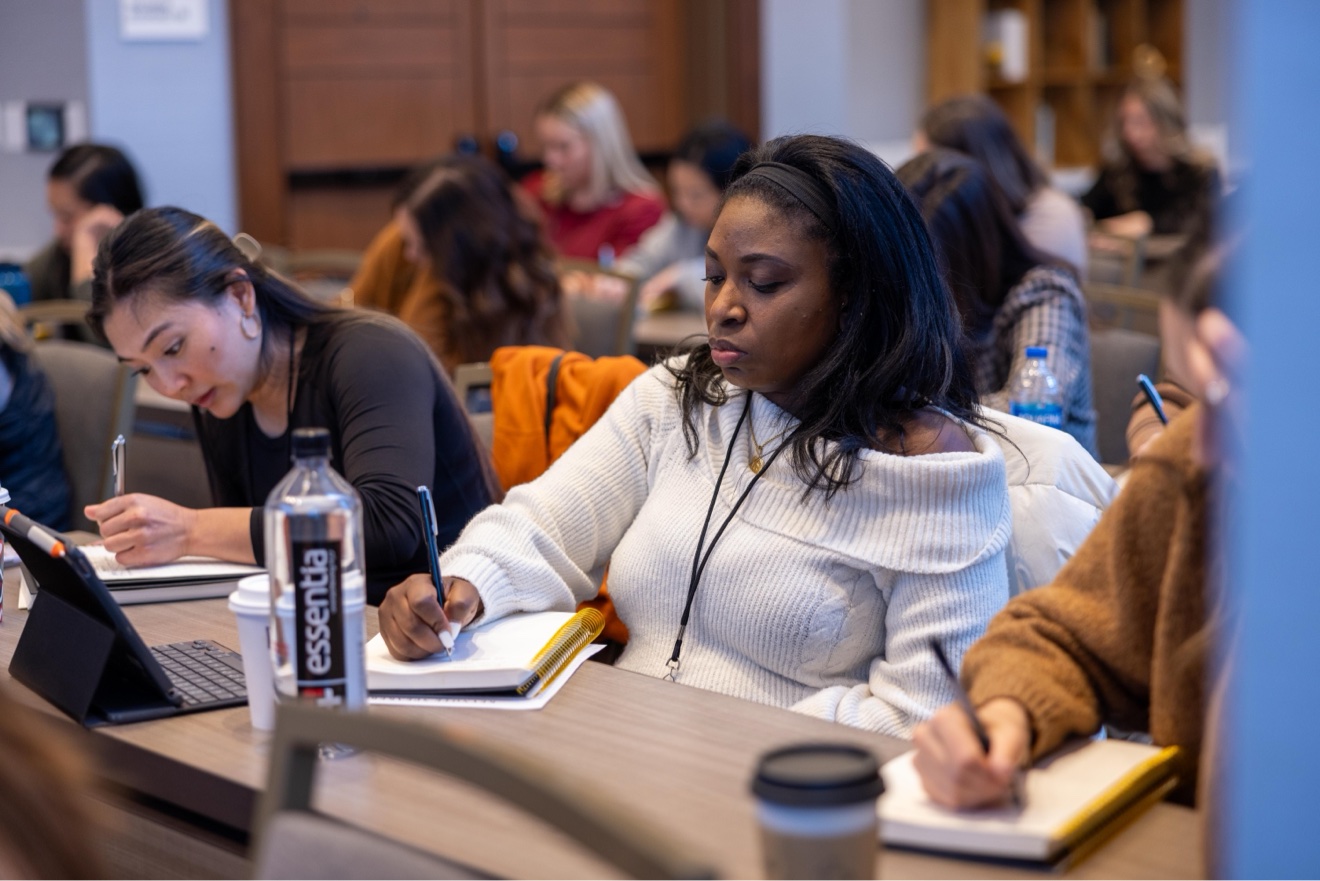 A member actively taking notes during training