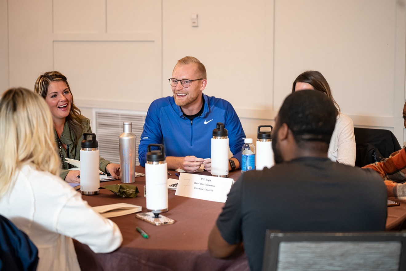 ChiroIntensive members laughing together at their table