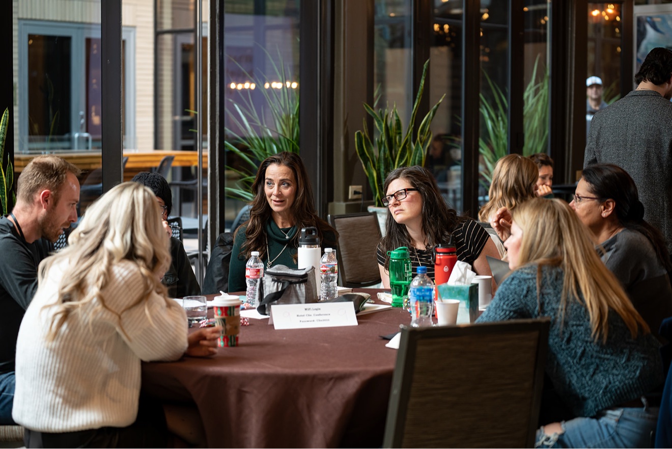Women members in deep conversation at a ChiroIntensive table