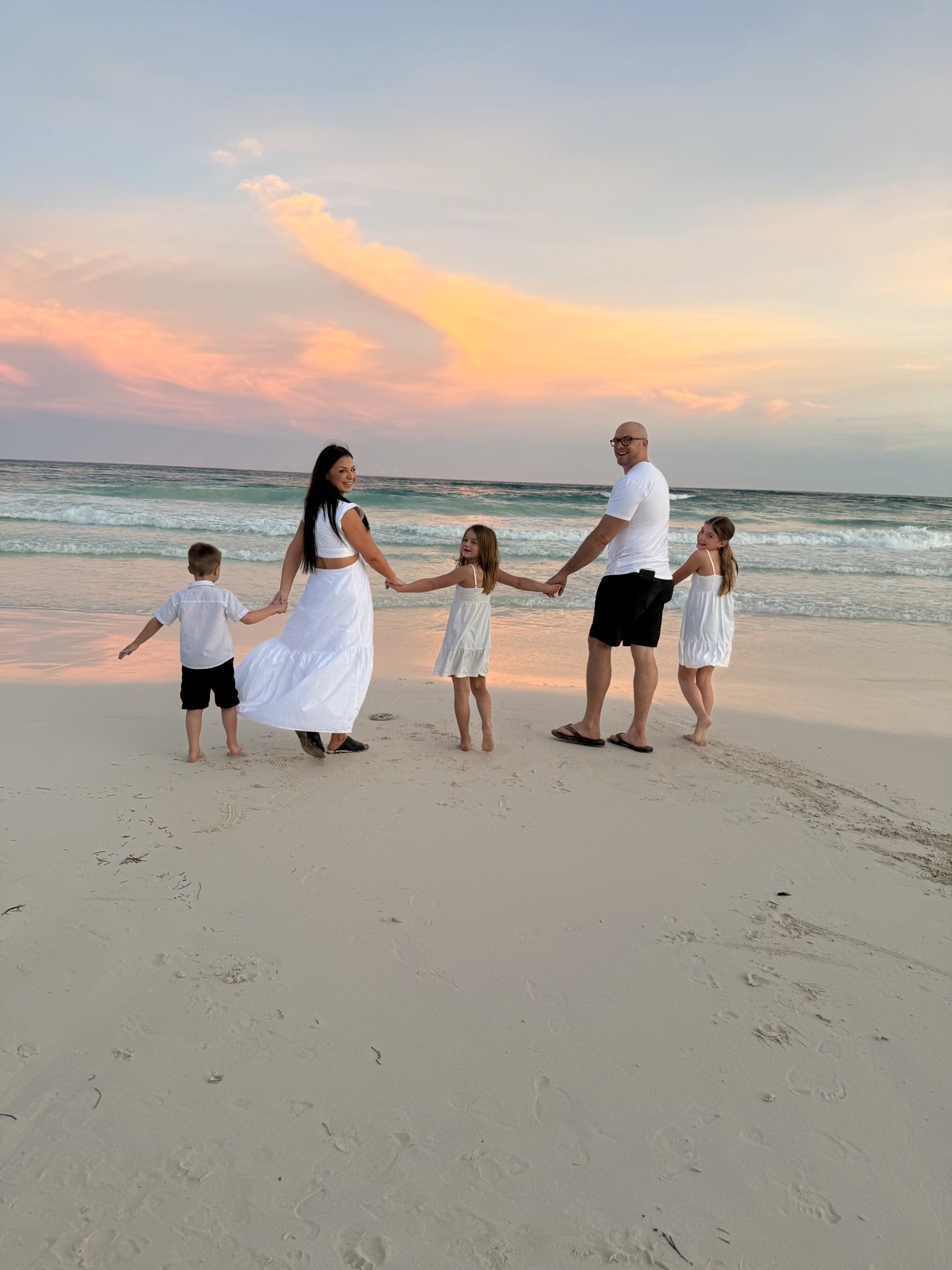 Dr. Elise with her family on the beach at sunset