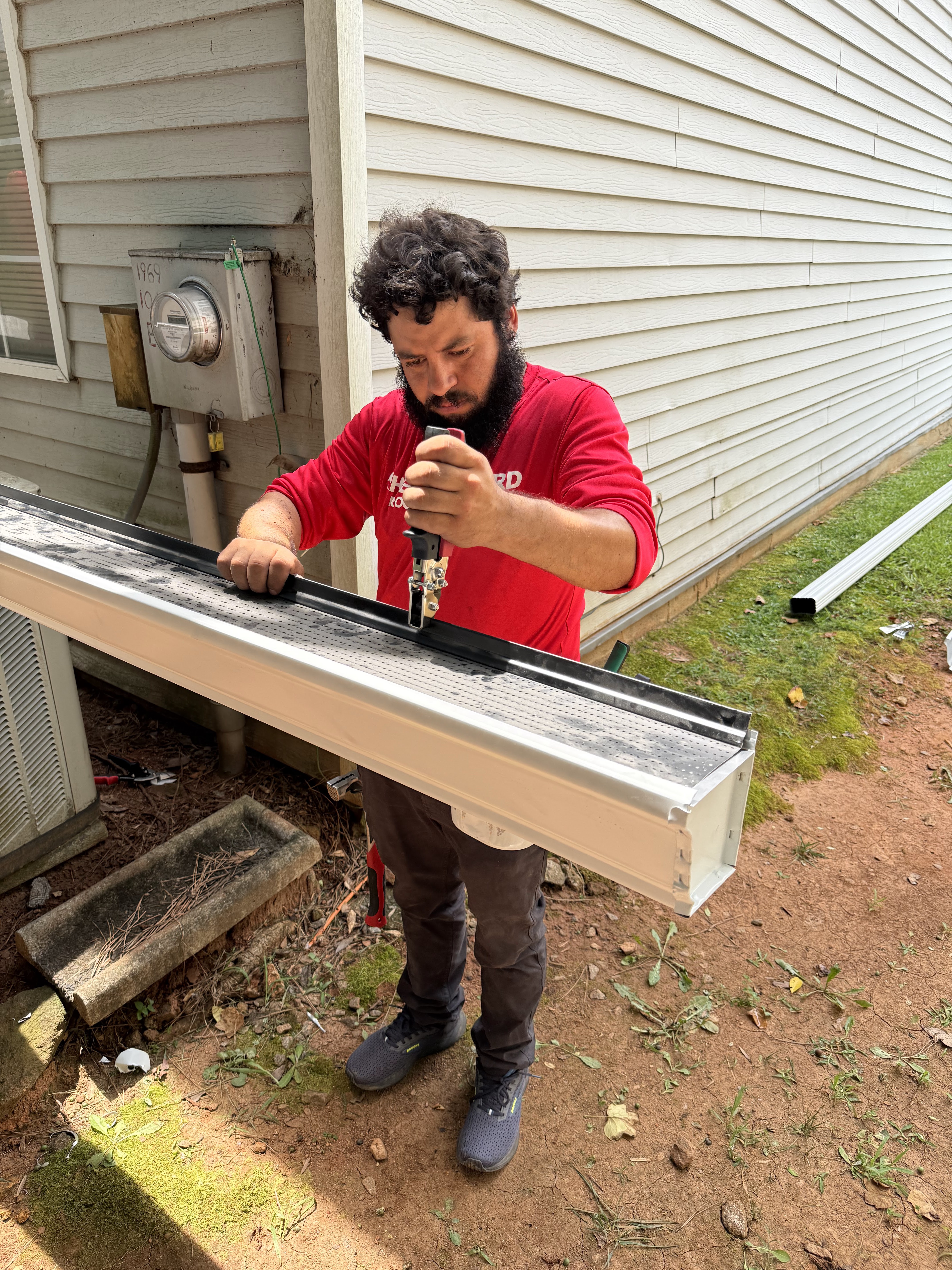 Shelter Guard technician checking a gutter section