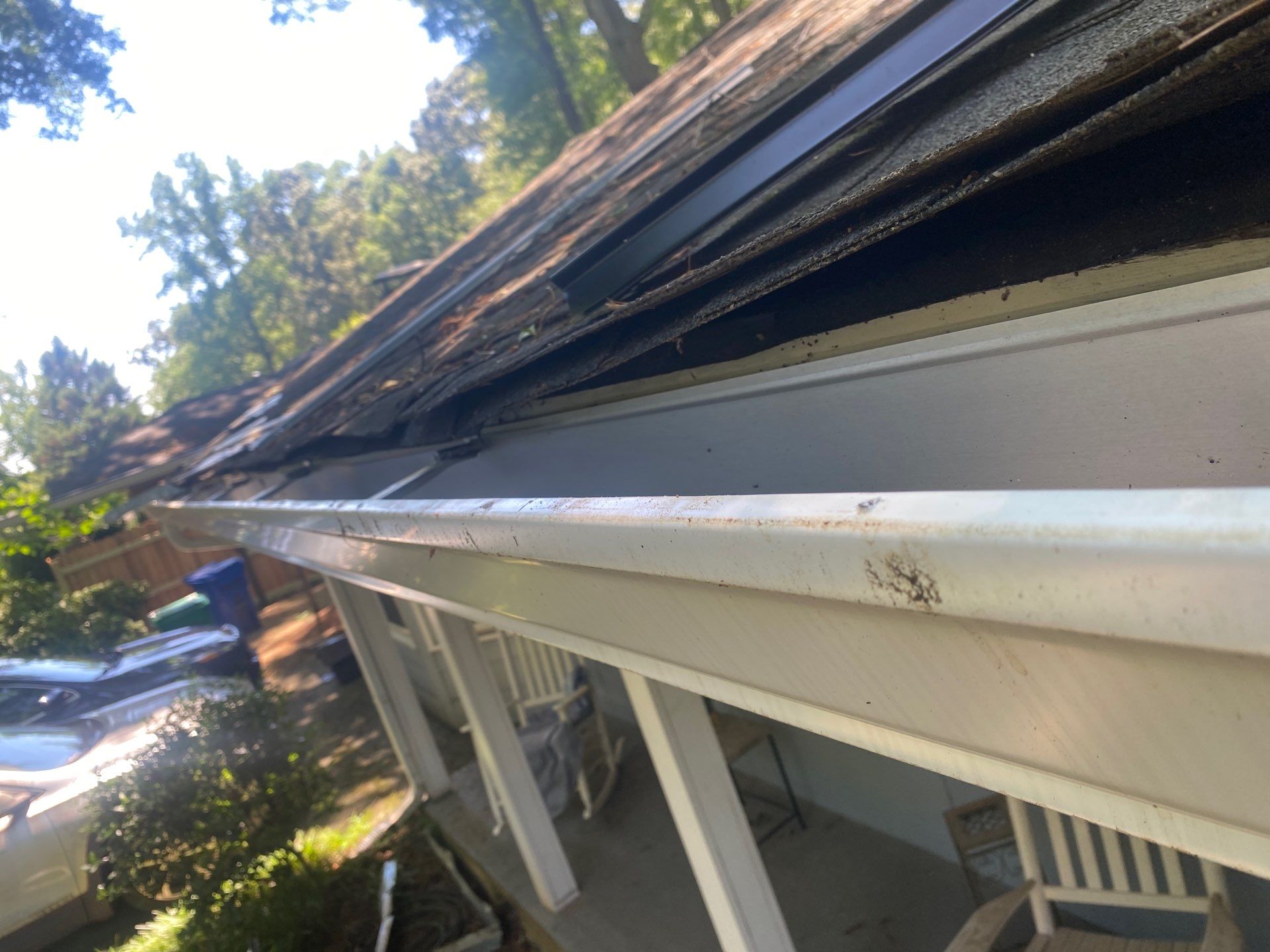 Length of gutter and fascia seen from the roof, showing the run being measured