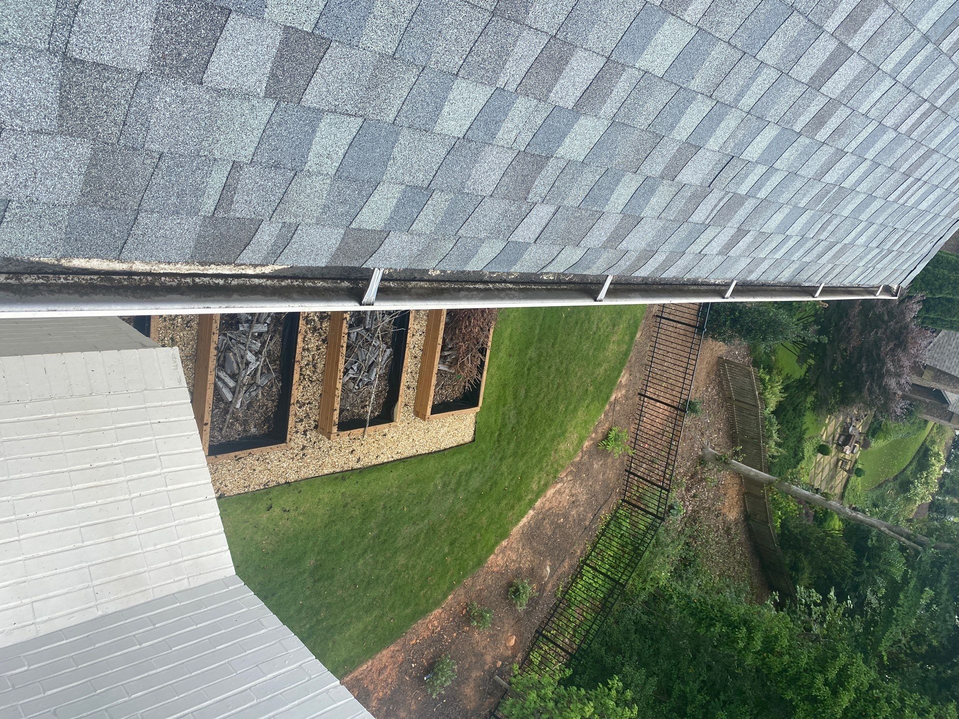 Soft, rotted fascia board behind a gutter run