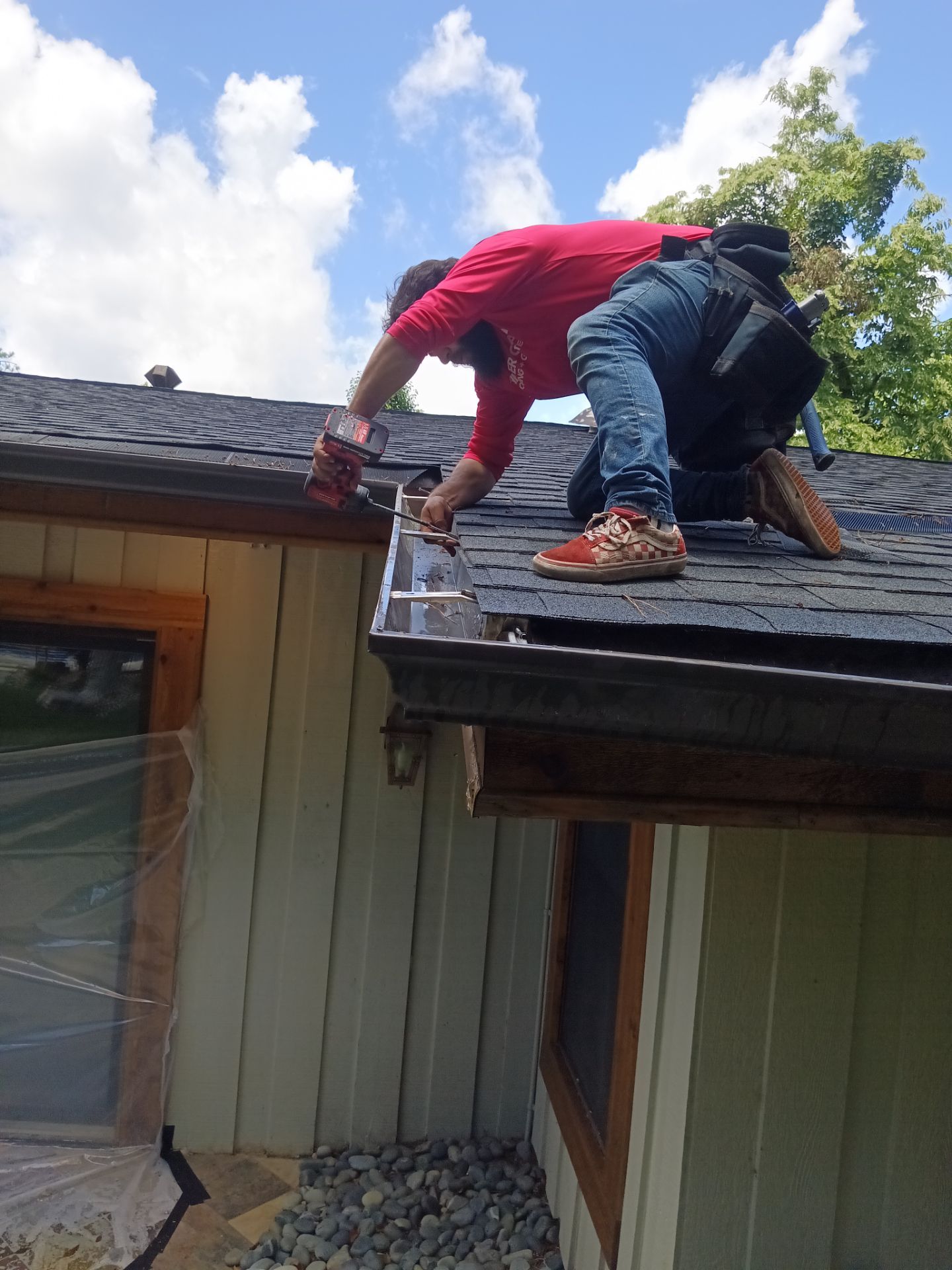 Technician repairing a sagging section of gutter