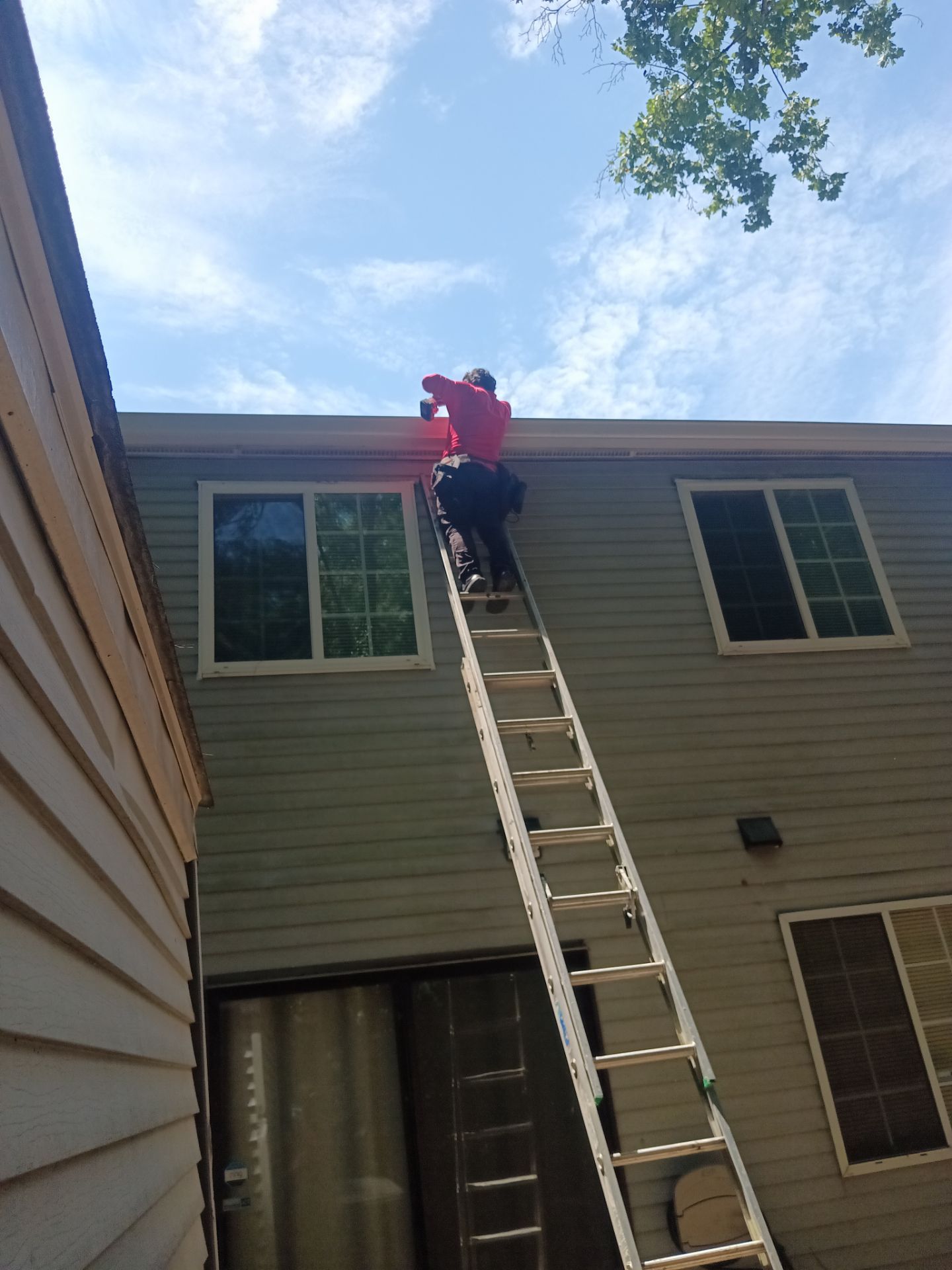 New custom-fit gutter run installed along a roofline