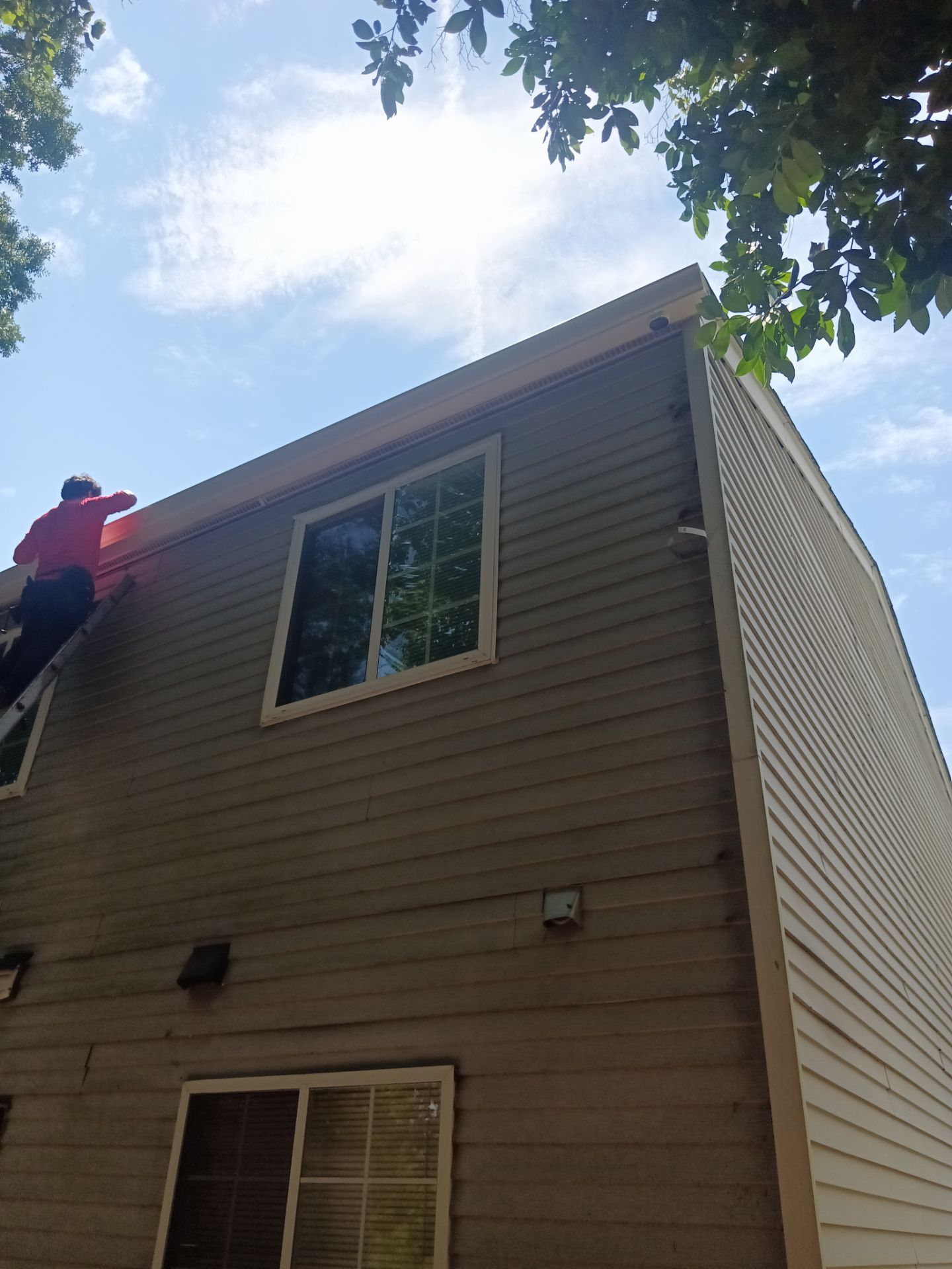 Rust streaking down siding below an old gutter run