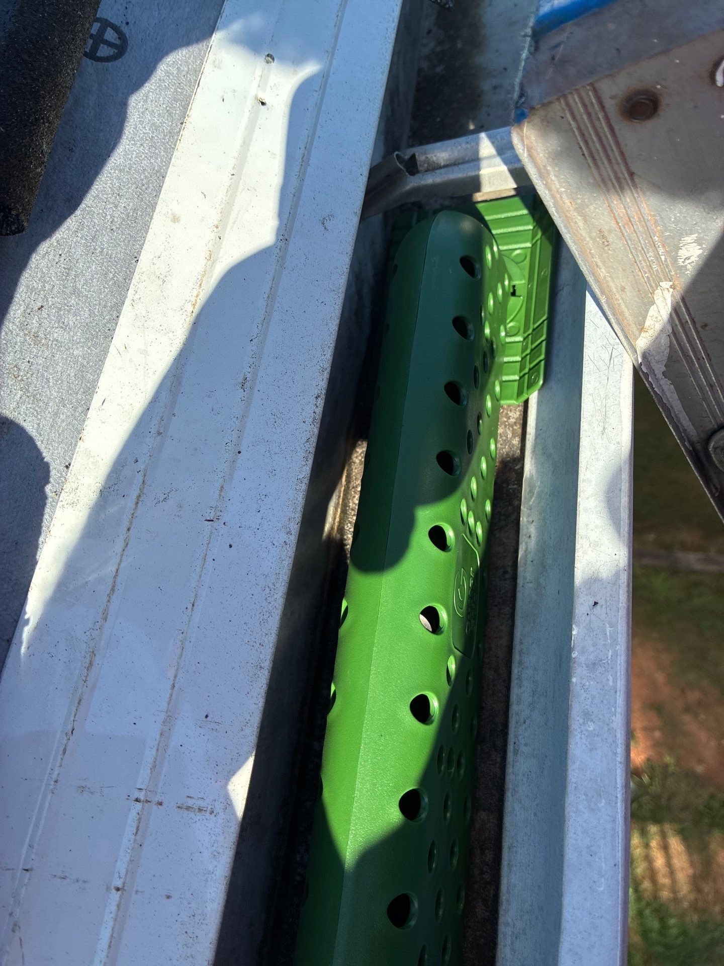 Gutter stick fitted at a downspout entry point