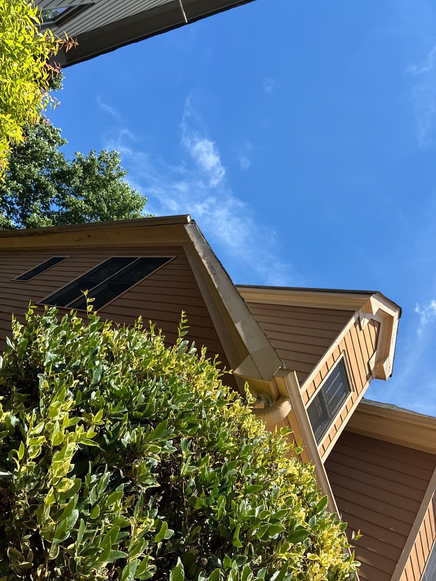 Damaged soffit panel with a visible gap under a roof edge