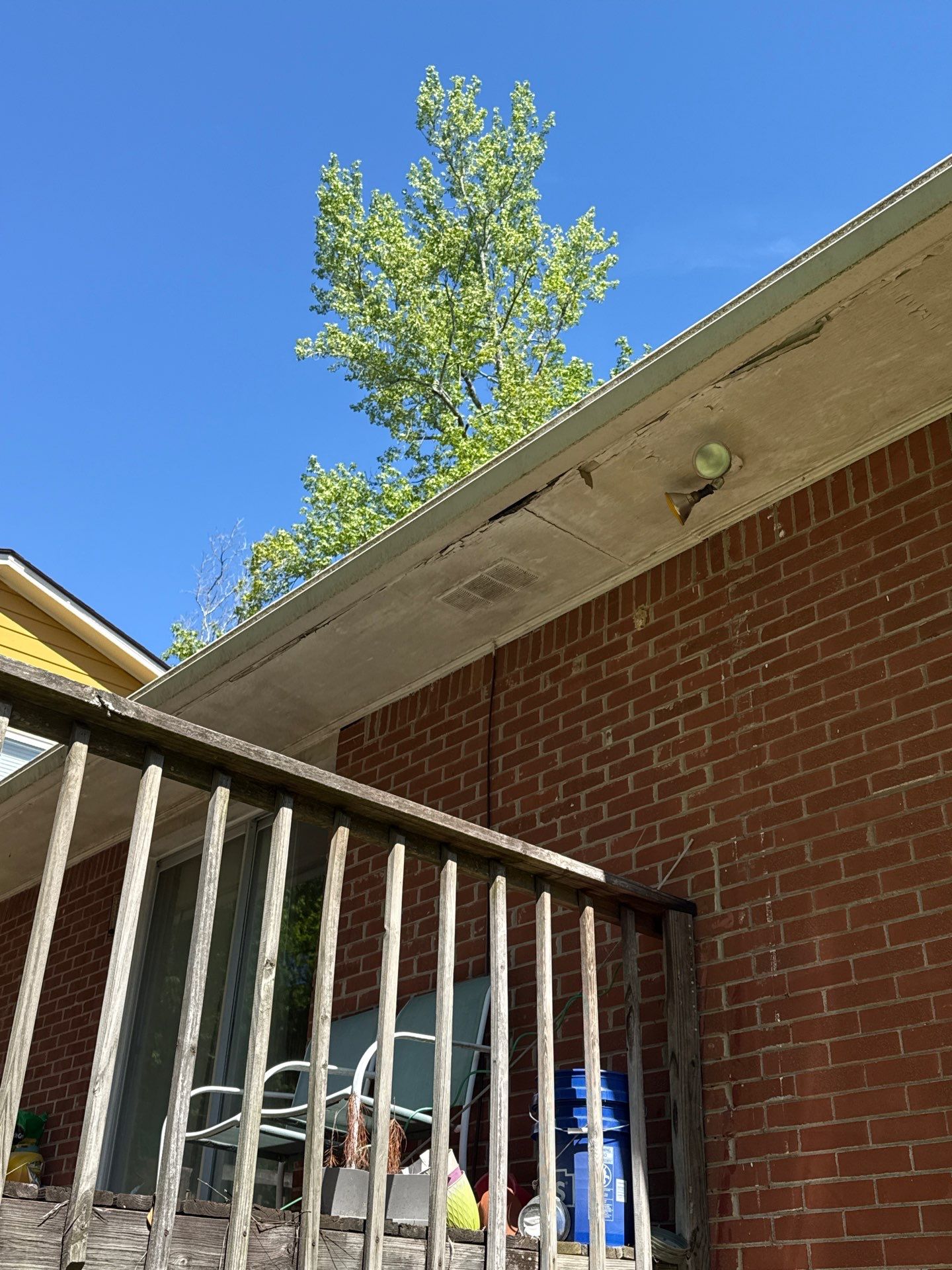 Porch roofline and soffit connection near a railing