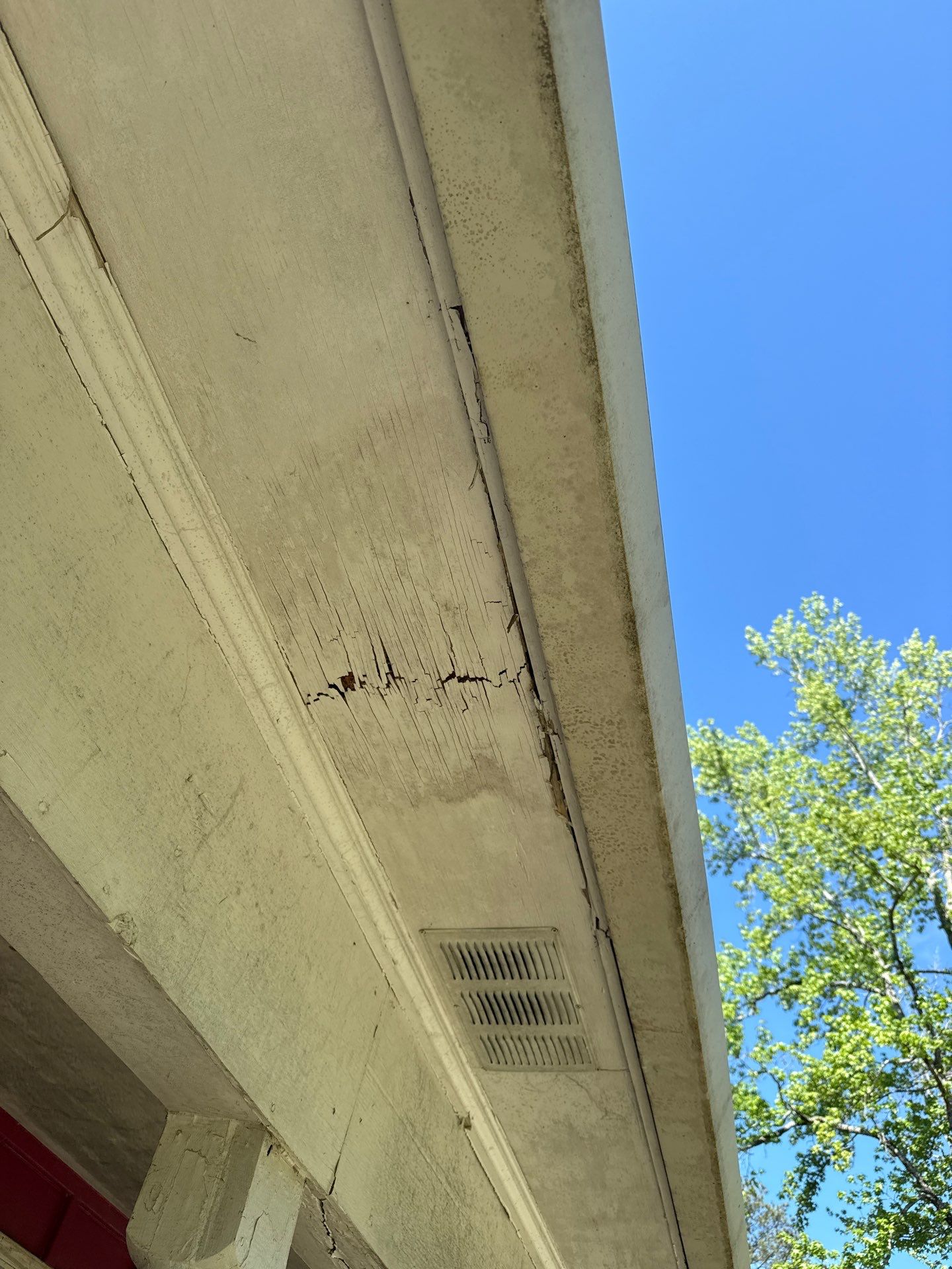 Cracked soffit panel with a split running through the board