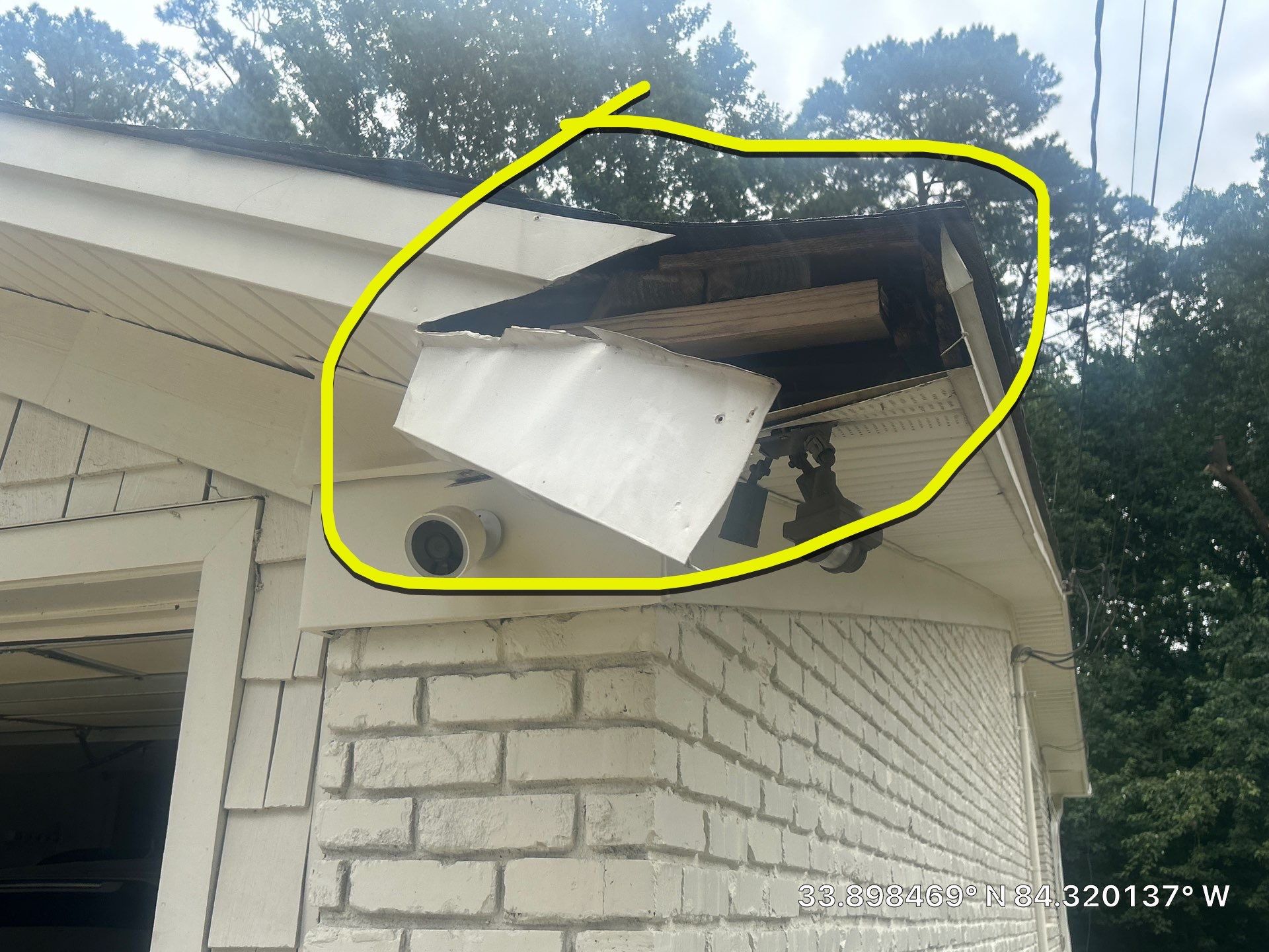Rotted fascia section circled to flag the damage during inspection