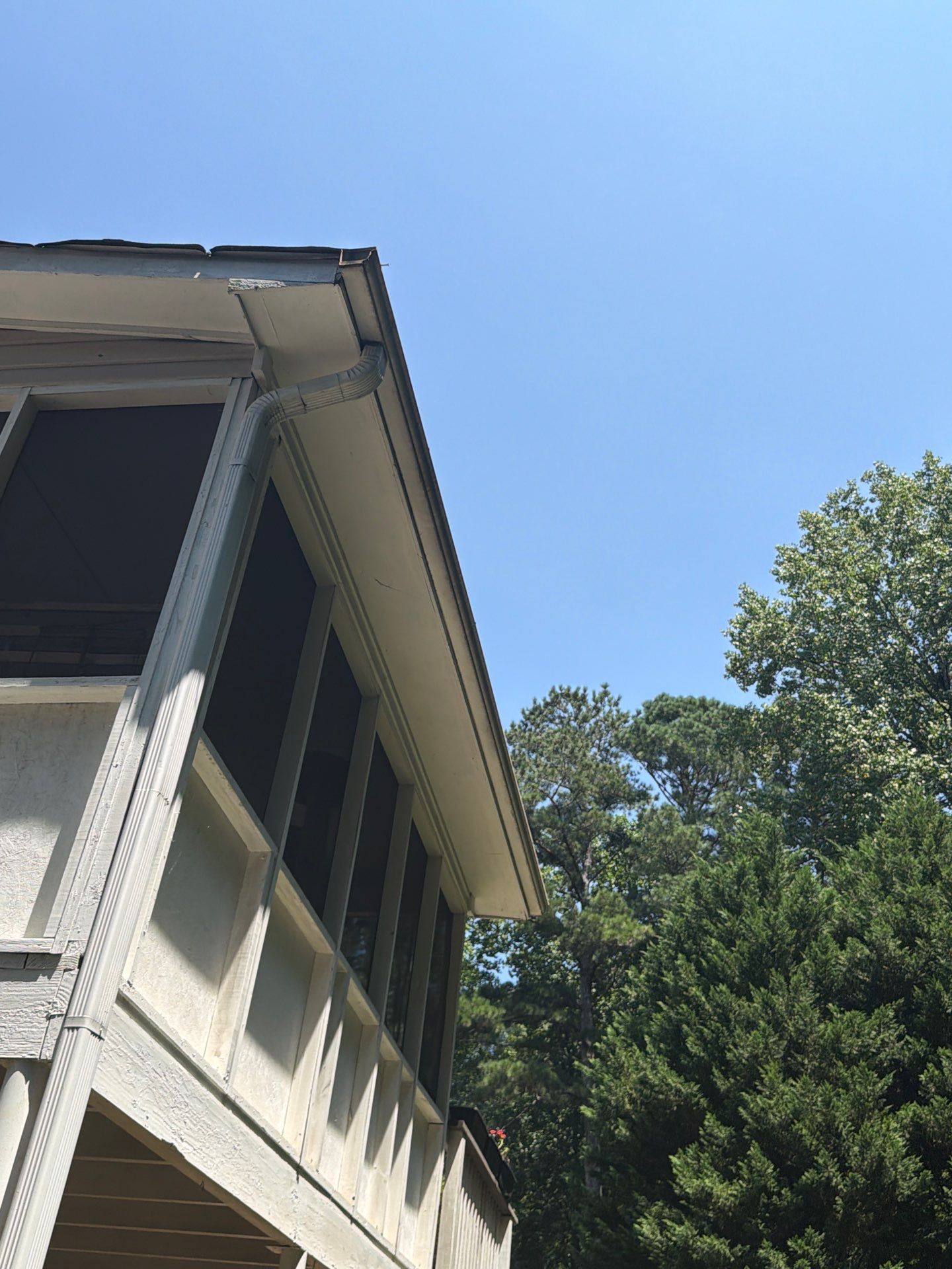 Screened porch corner with the gutter and fascia line above