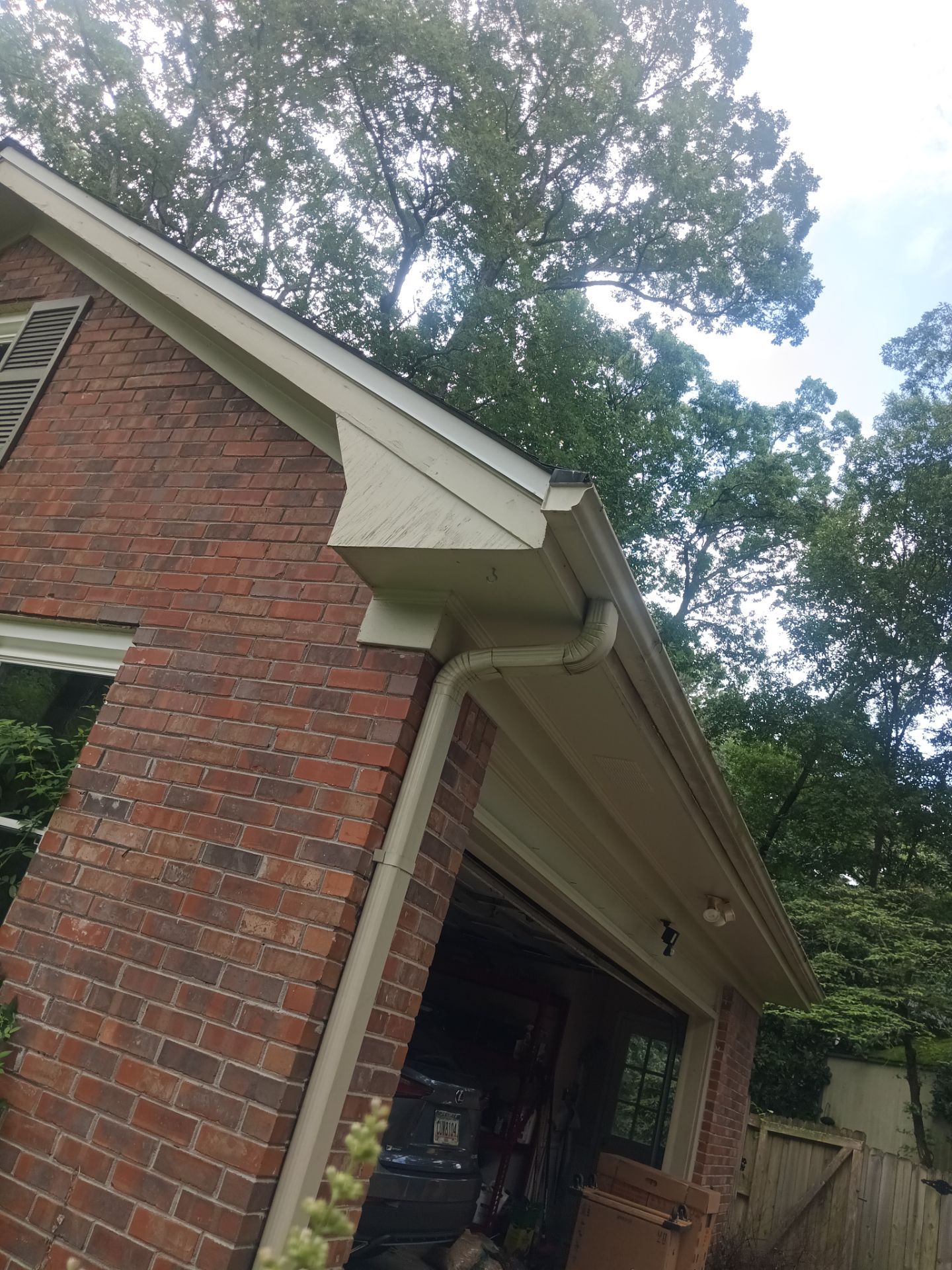 Brick home corner with the fascia and gutter line above the entry