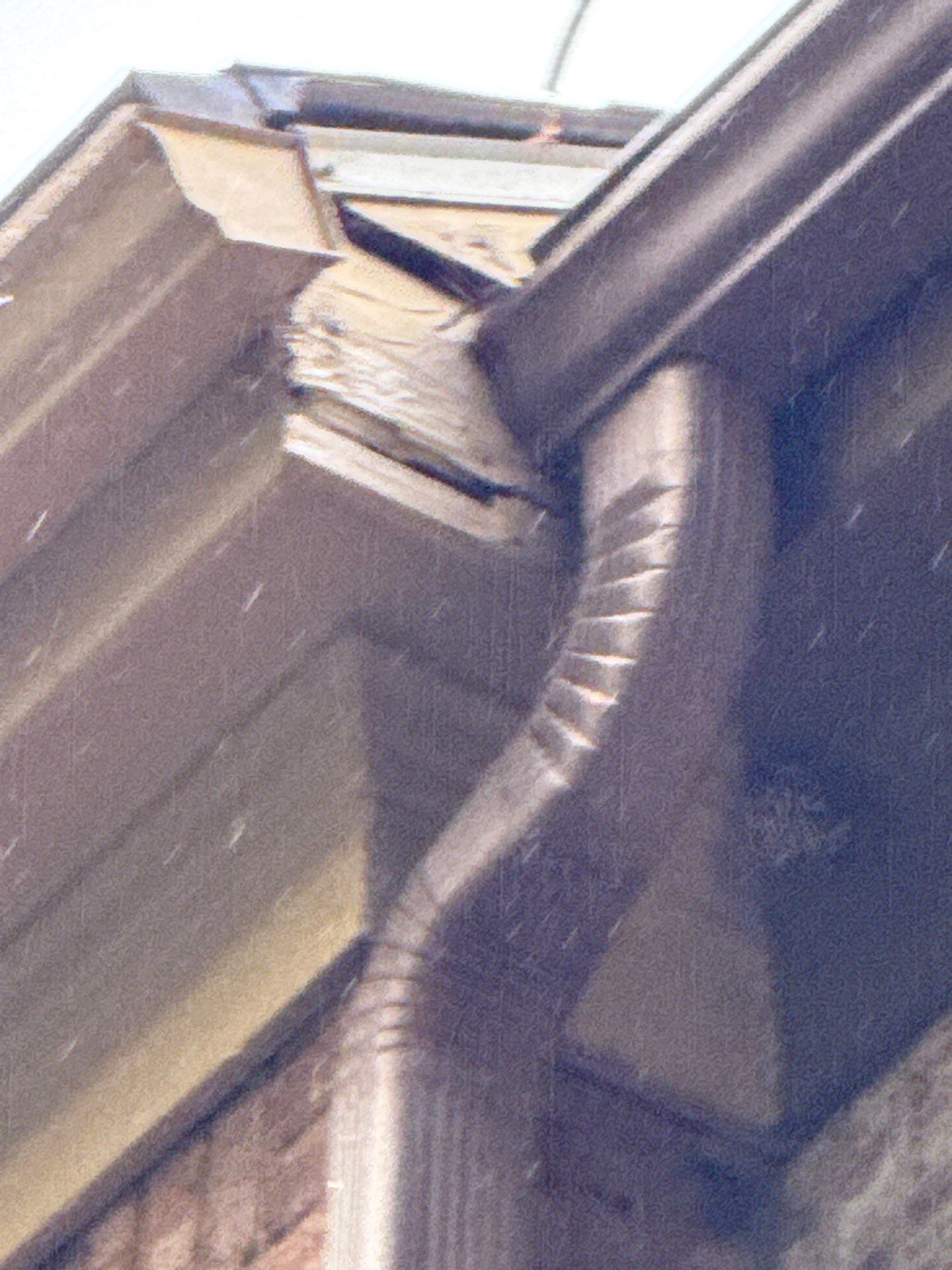 Fascia board along a roofline with a gutter attached