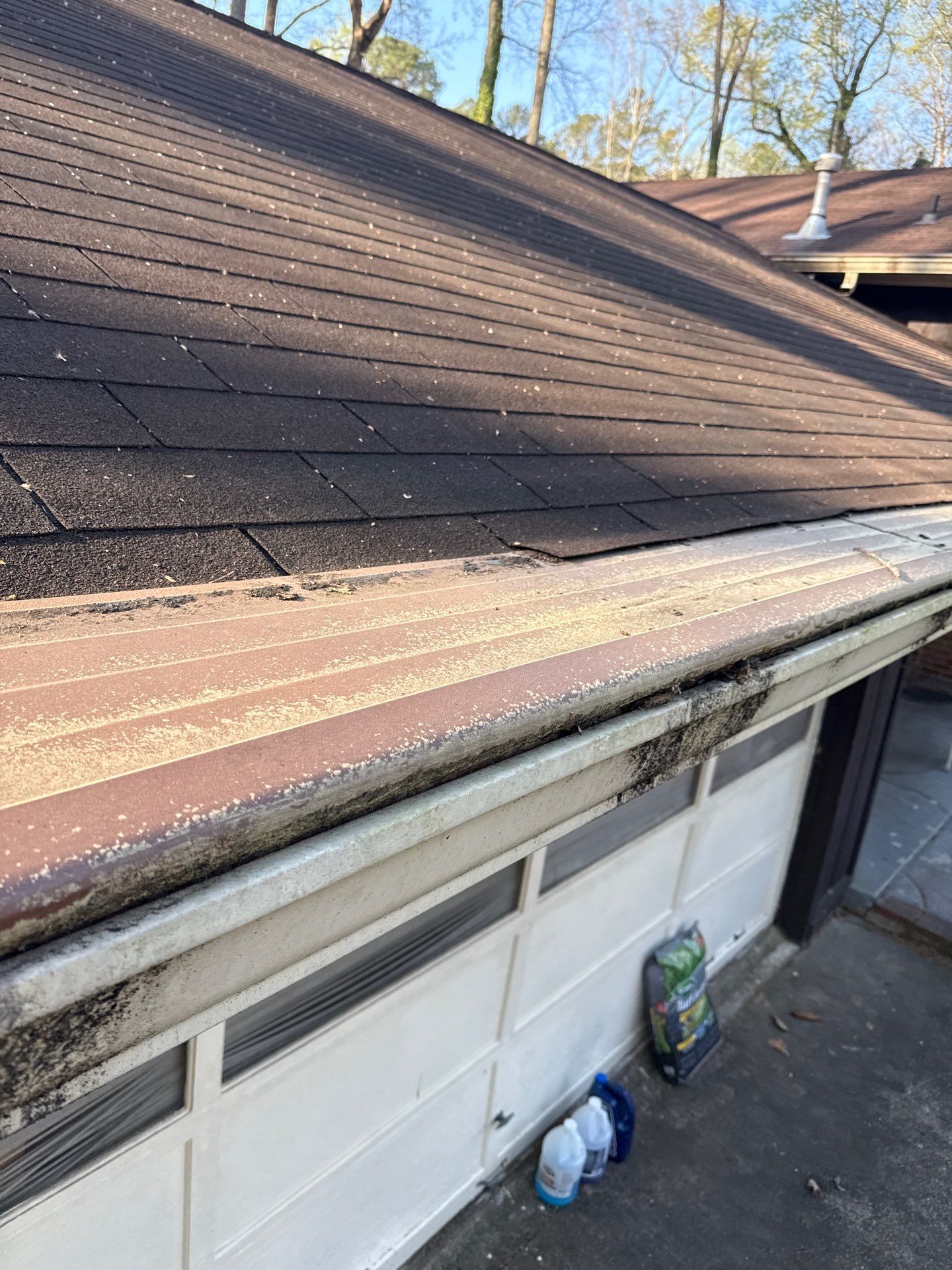 Gutter along the roofline above a garage door