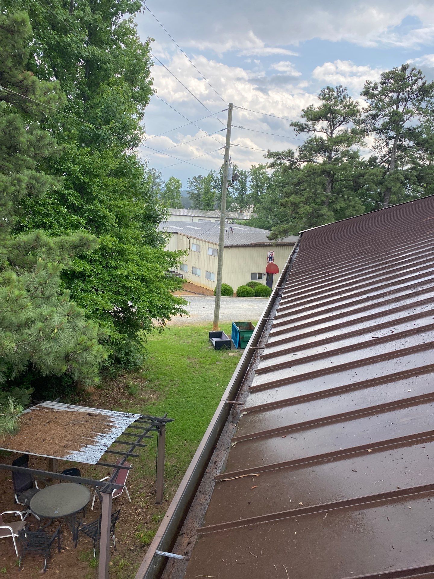 Commercial metal roofline with trees behind
