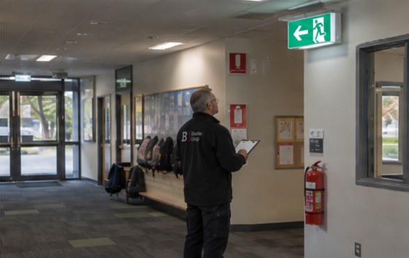 Inspector checking exit signage