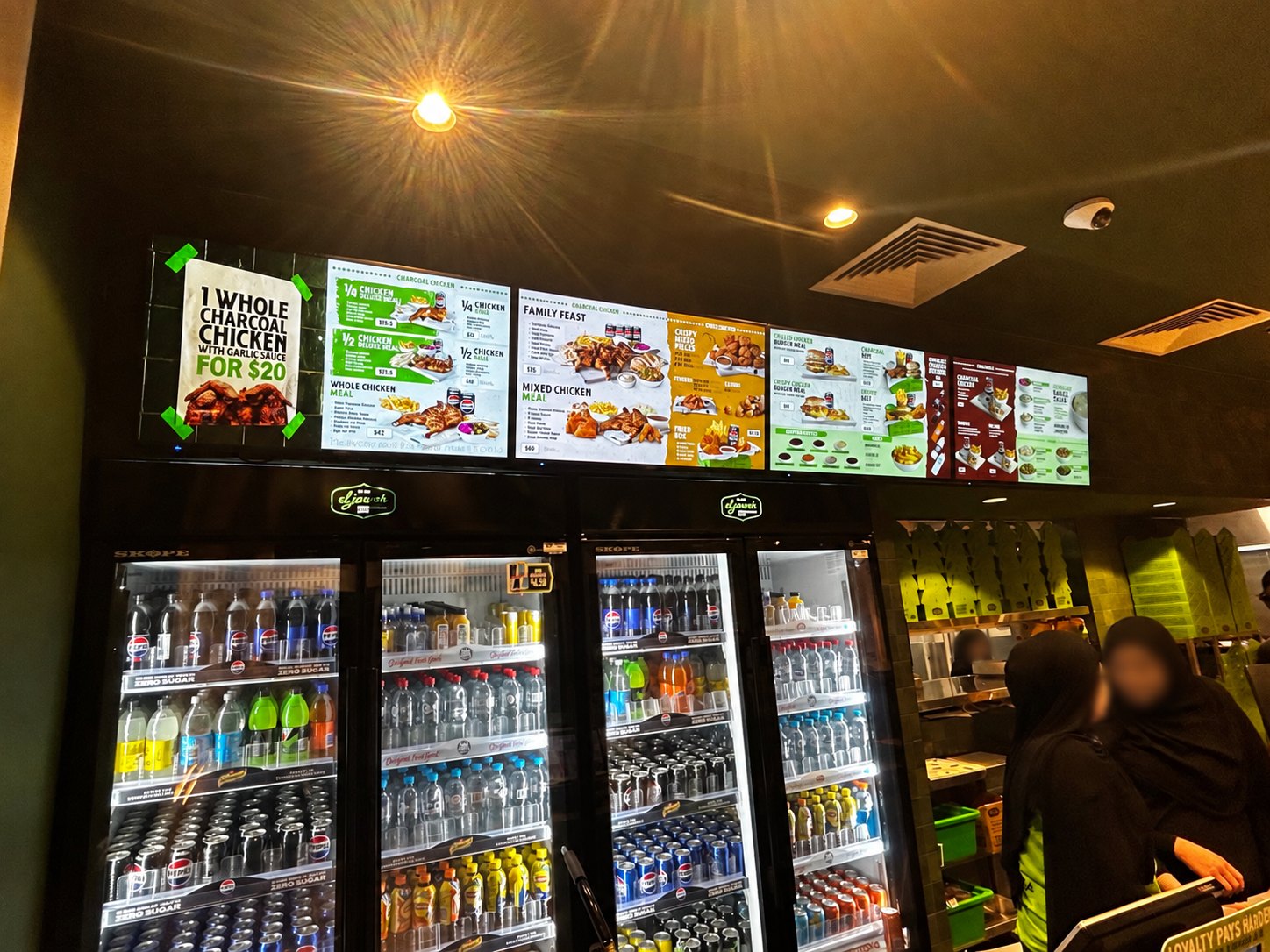 El Jannah restaurant interior with digital menu boards