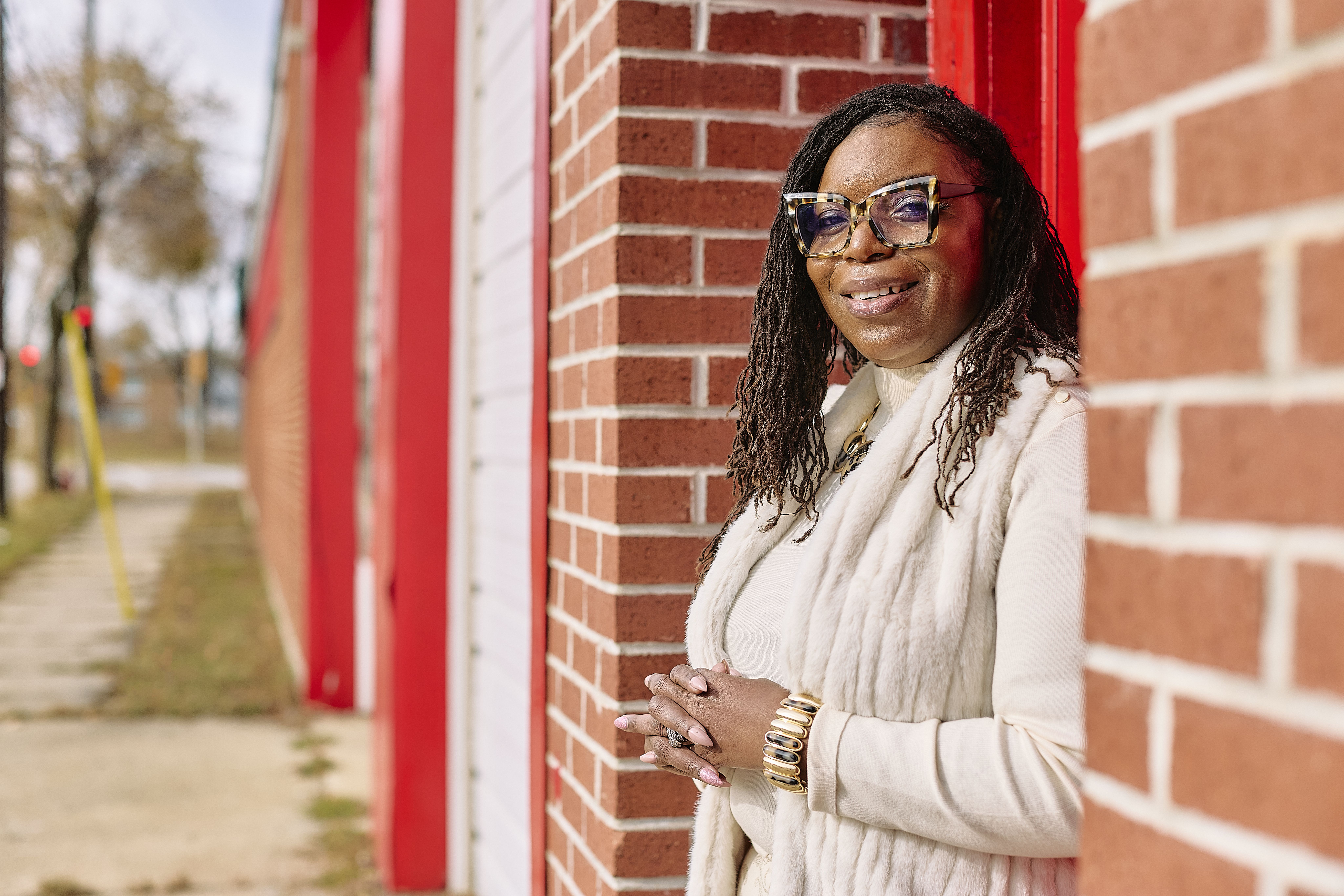 Natasha Broxton standing outside by a brick wall
