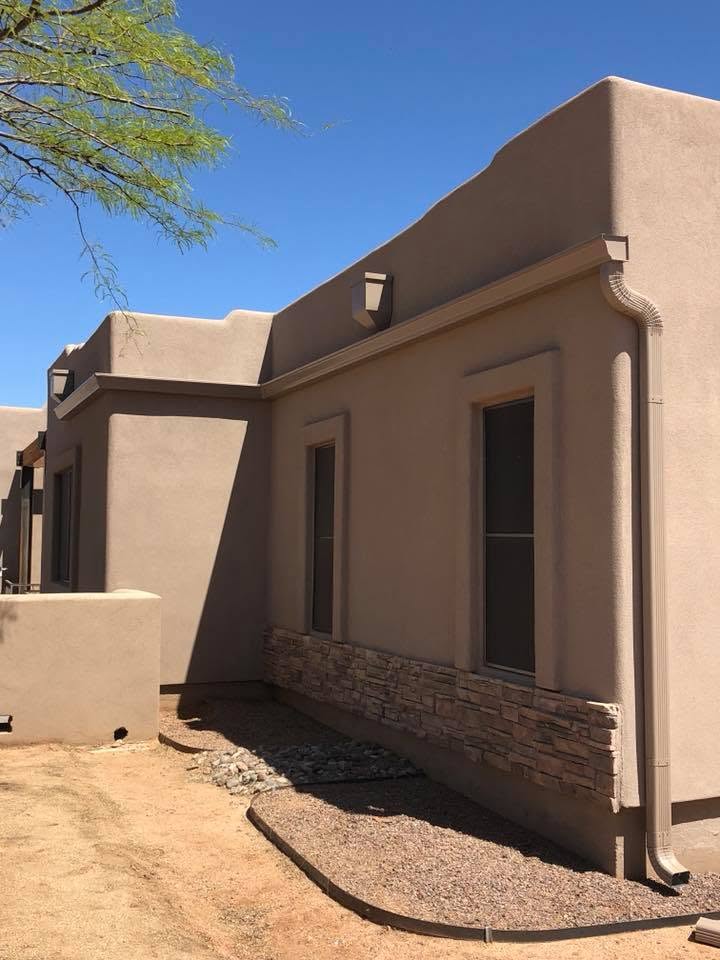 Seamless gutter along the parapet of a southwestern stucco Phoenix home