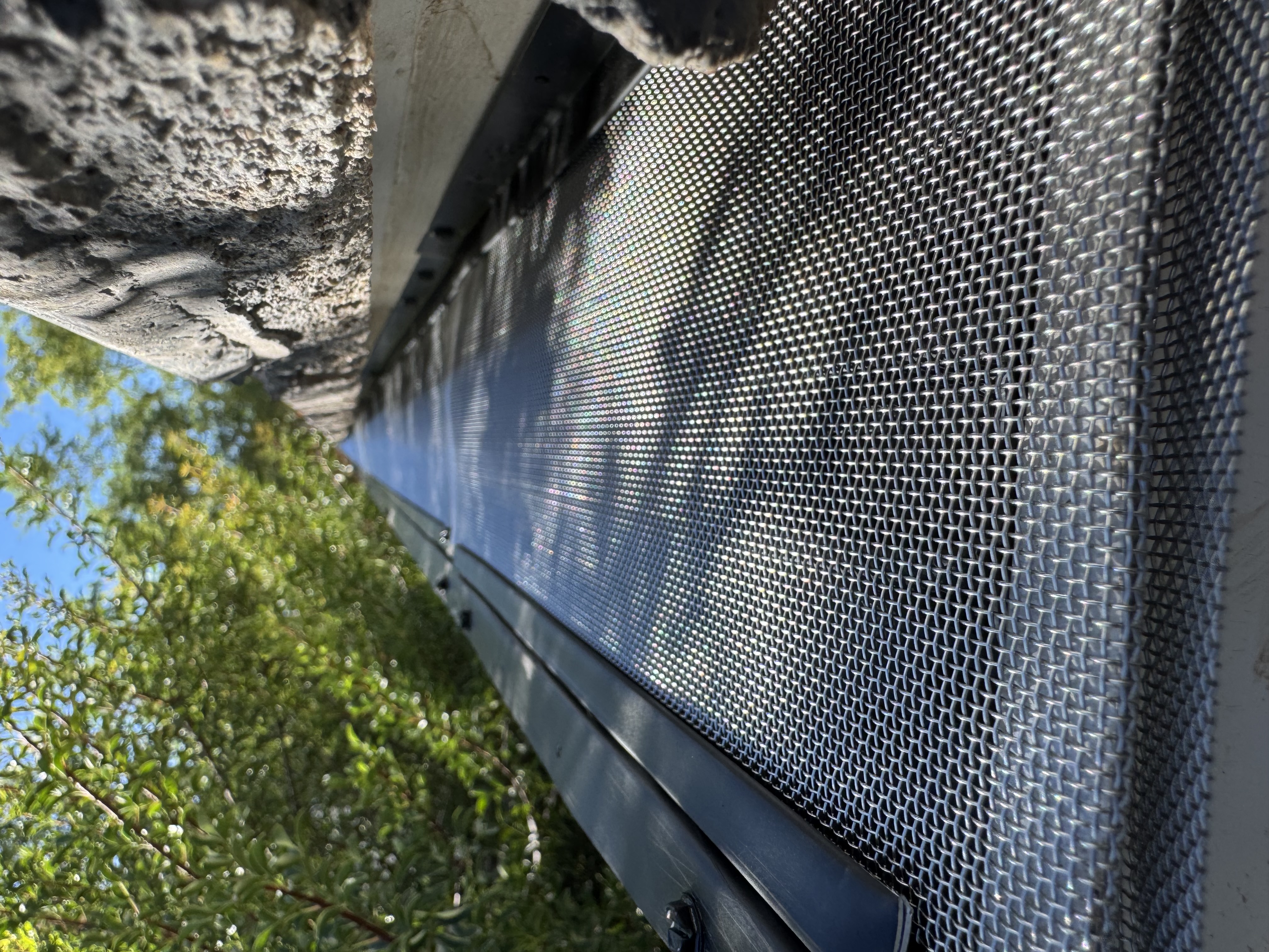Micro-mesh gutter screen fitted along a seamless gutter run