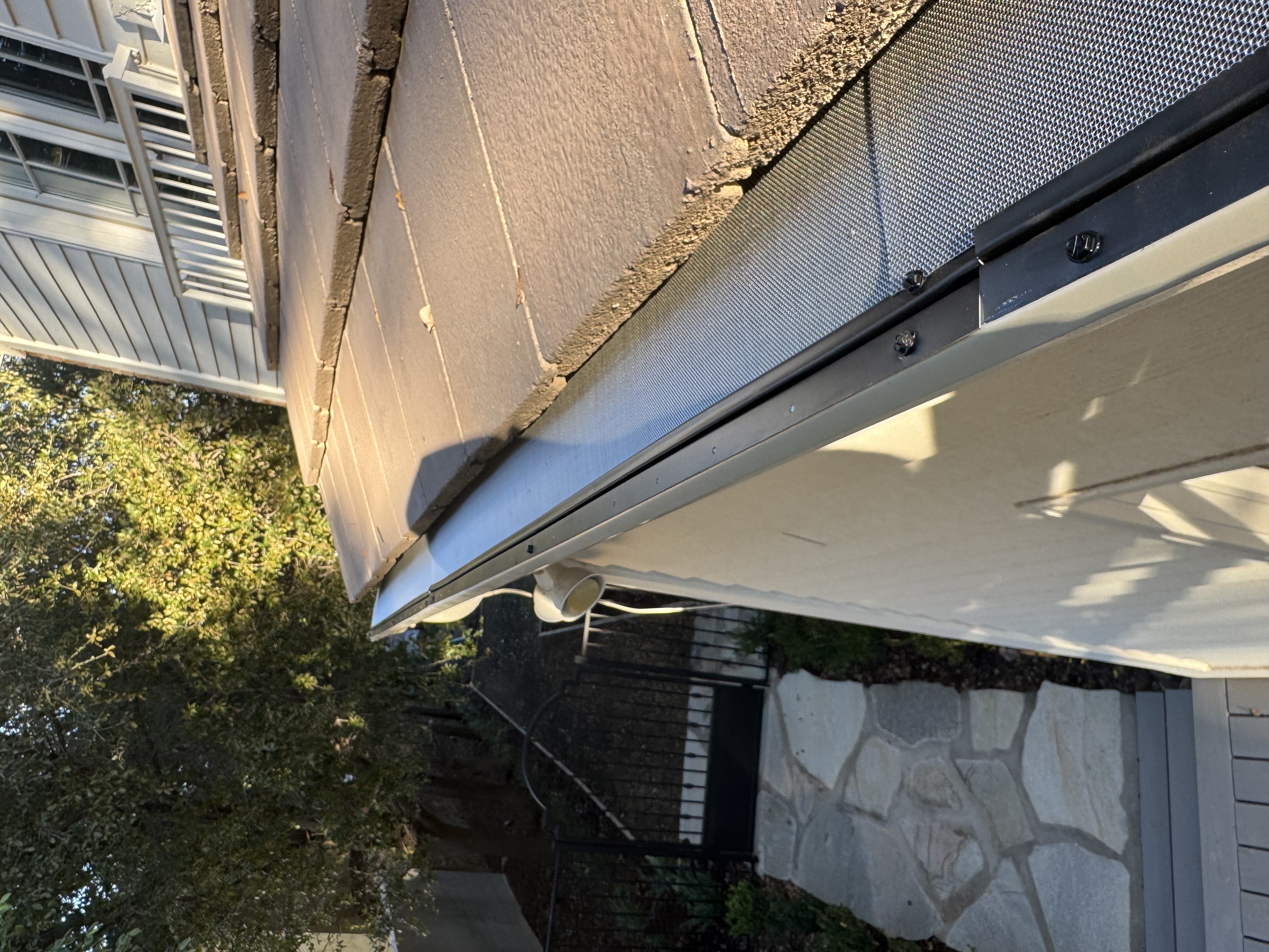 Micro-mesh gutter screen fitted along a tile-roof gutter run on a Phoenix home
