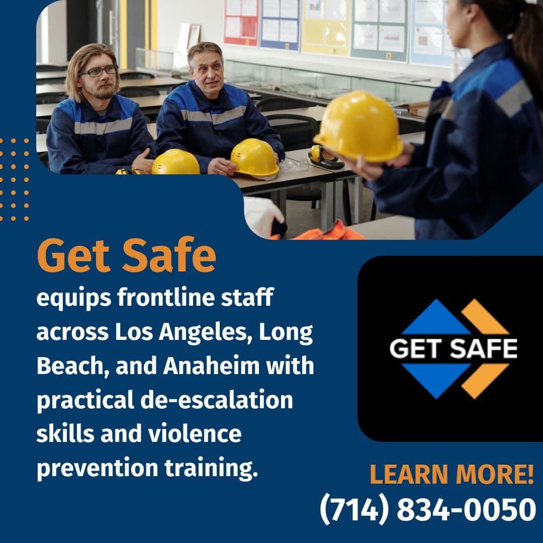 Workplace safety training session with staff wearing helmets and instructor presenting