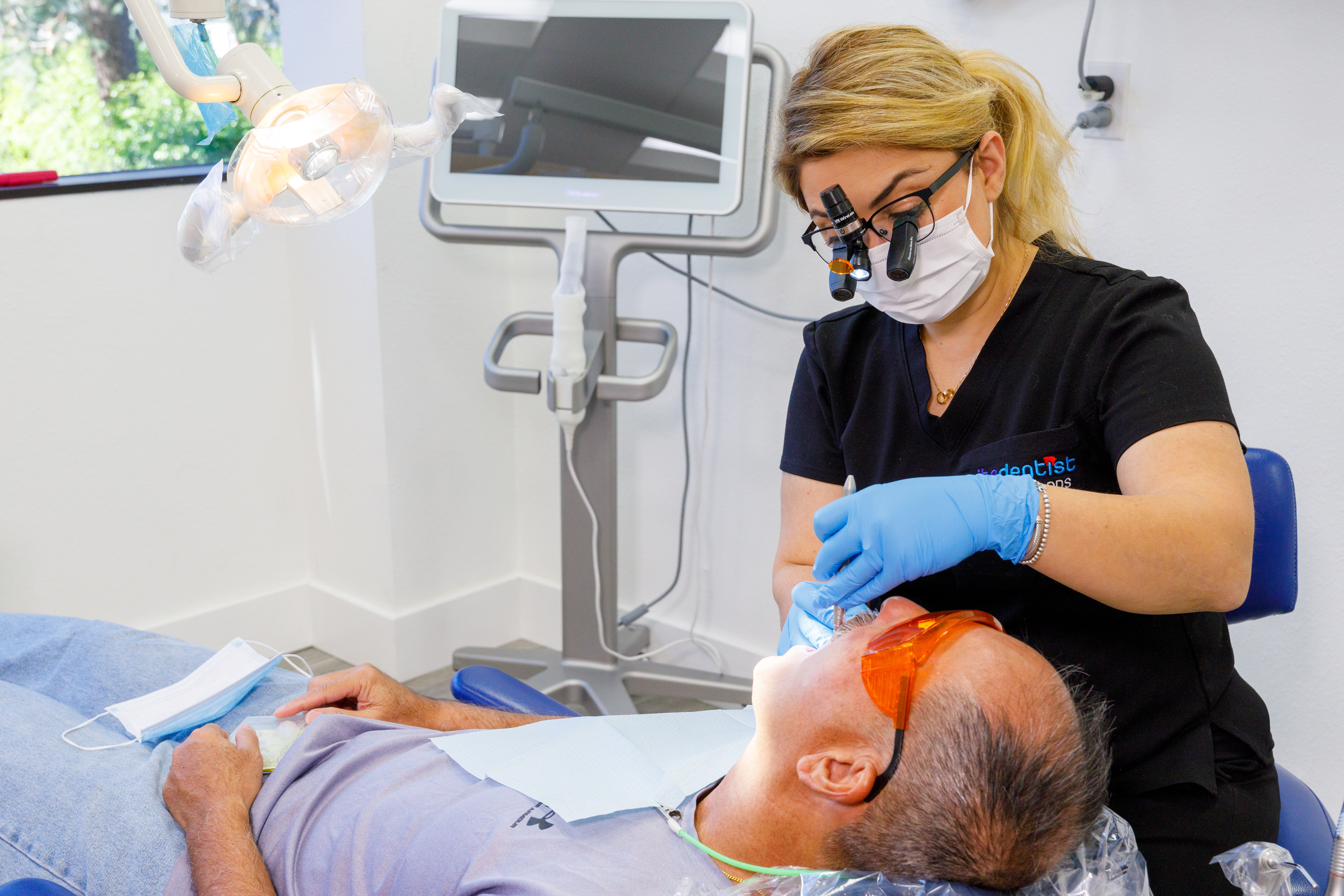 Dr. Babrood performing dental treatment with precision loupes