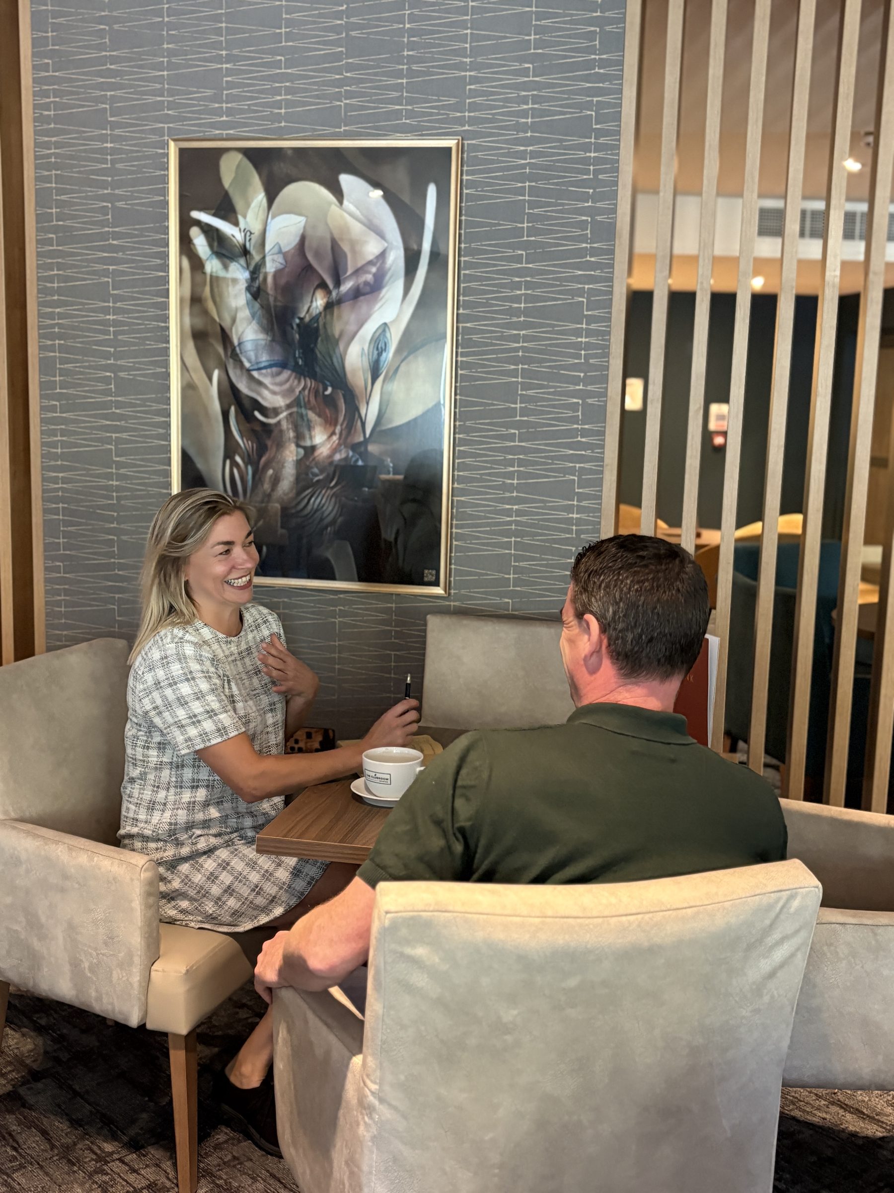 Sarah Jones in a meeting with a client in a hotel lounge