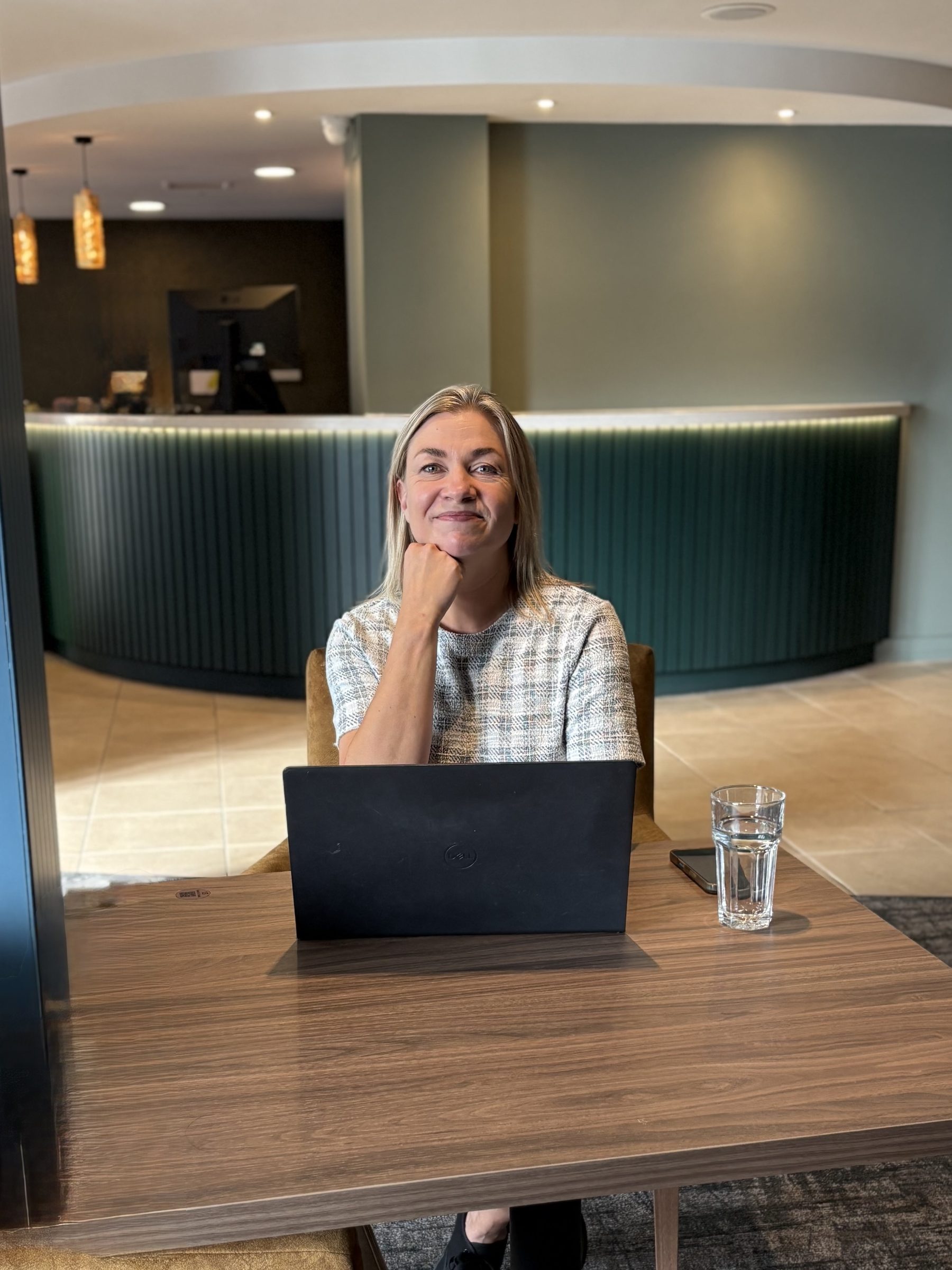 Sarah Jones smiling in a hotel lobby